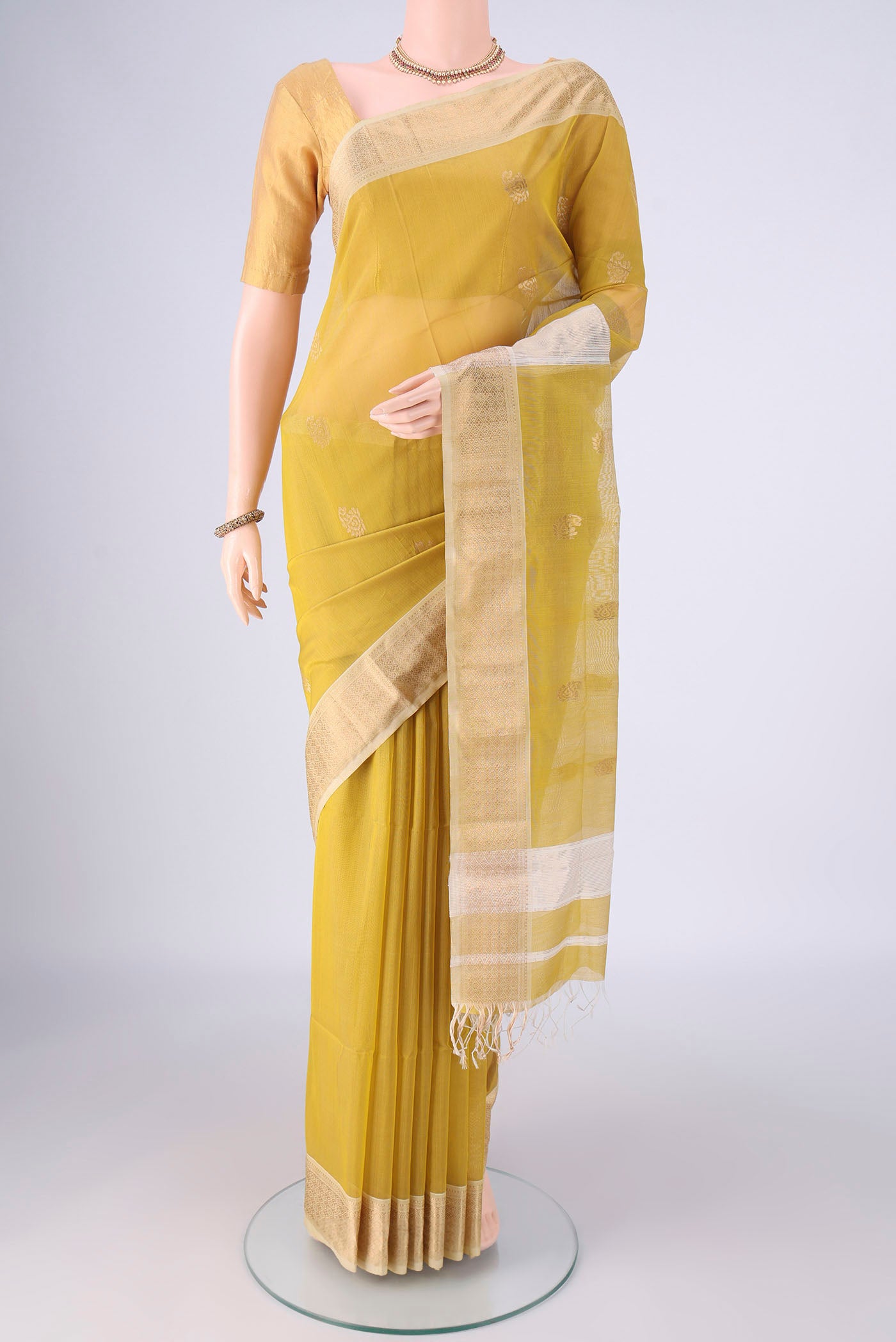 Yellow Maheshwari Silk Cotton Saree with Zari Butta on the body and Zari Border.  displayed on a mannequin