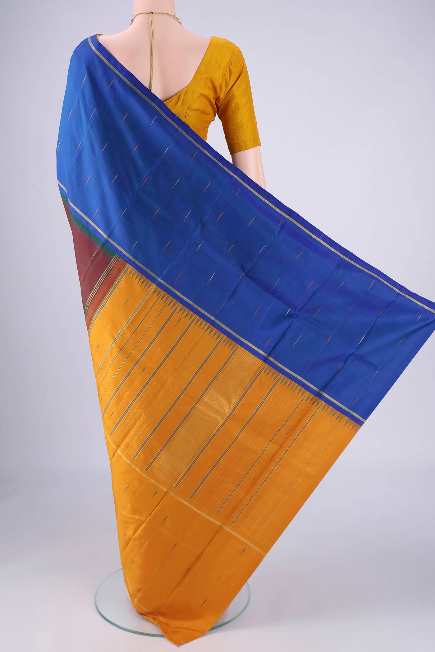 Flat view of Maroon Kanjivaram Silk Saree with Zari And Thread Butta on the body and Ganga Jamuna Border. 