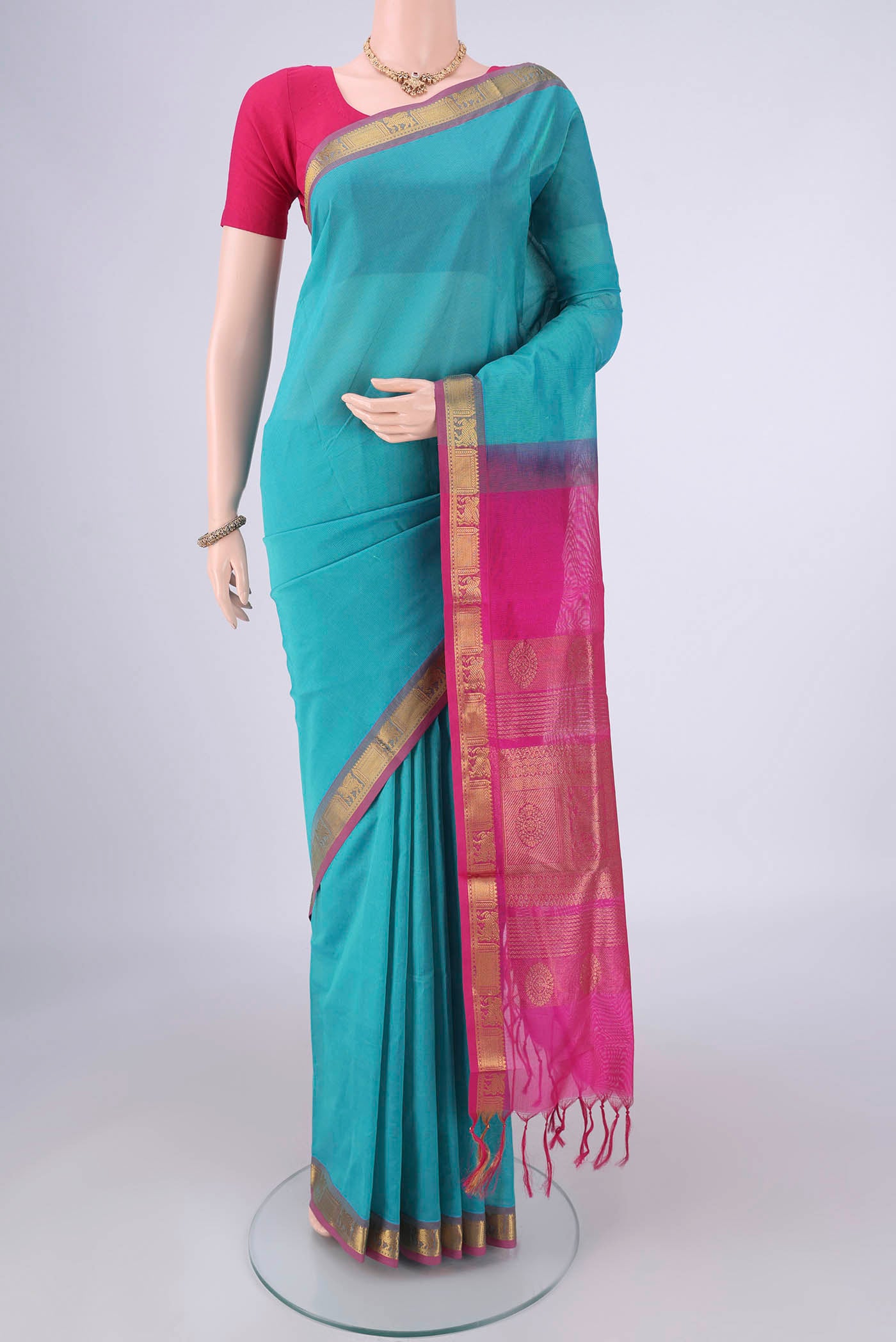 Turquoise Silk Cotton Saree with Plain Body and Zari Border.  displayed on a mannequin