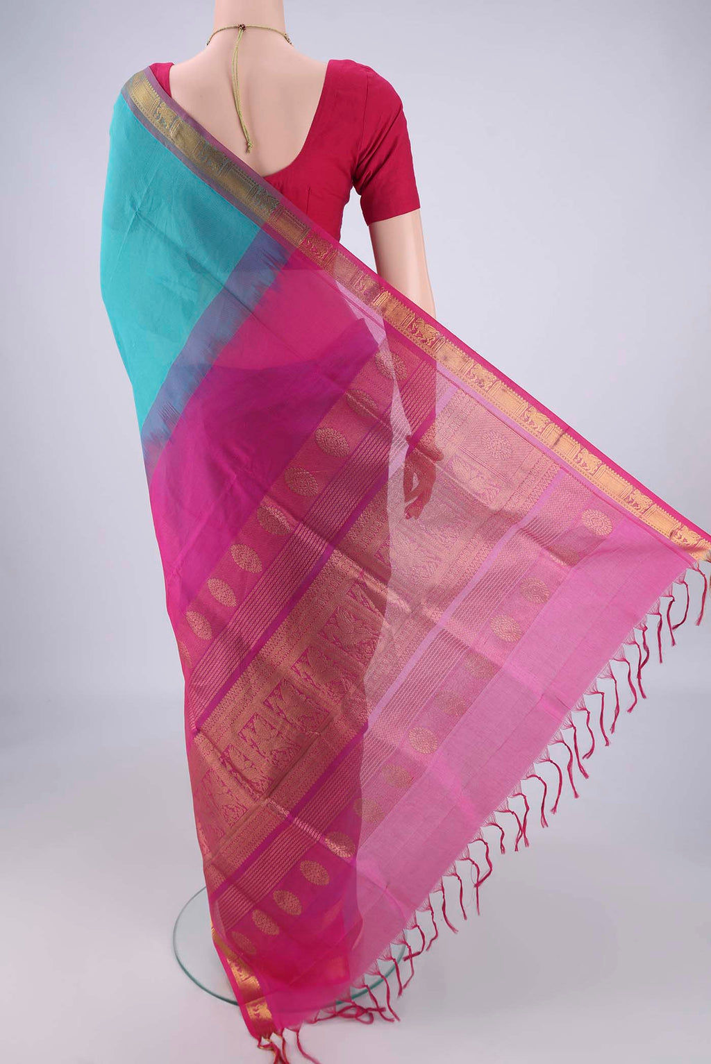 Flat view of Turquoise Silk Cotton Saree with Plain Body and Zari Border. 