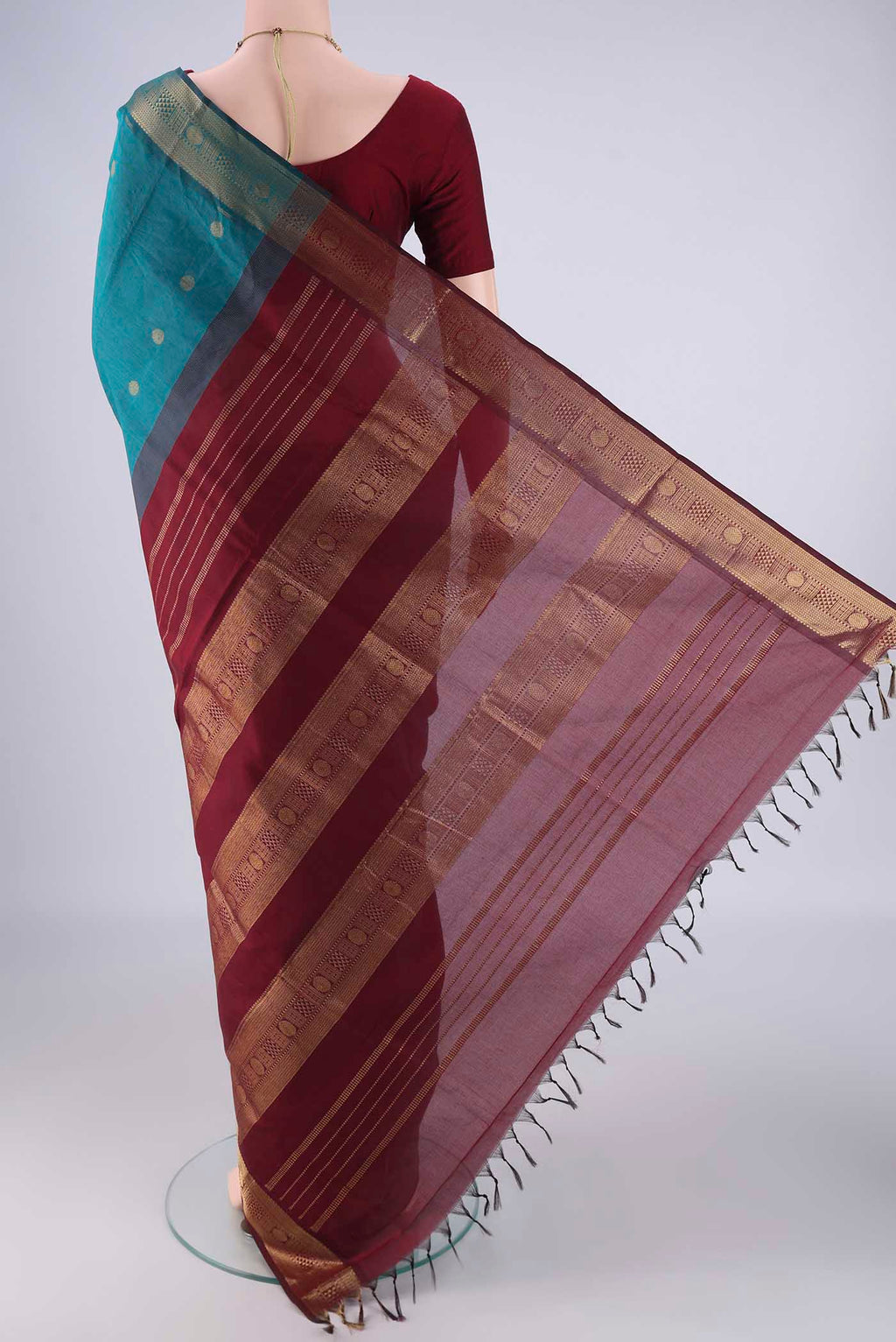Flat view of Teal Blended Poly Cotton Saree with Zari Butta on the body and Zari Border. 