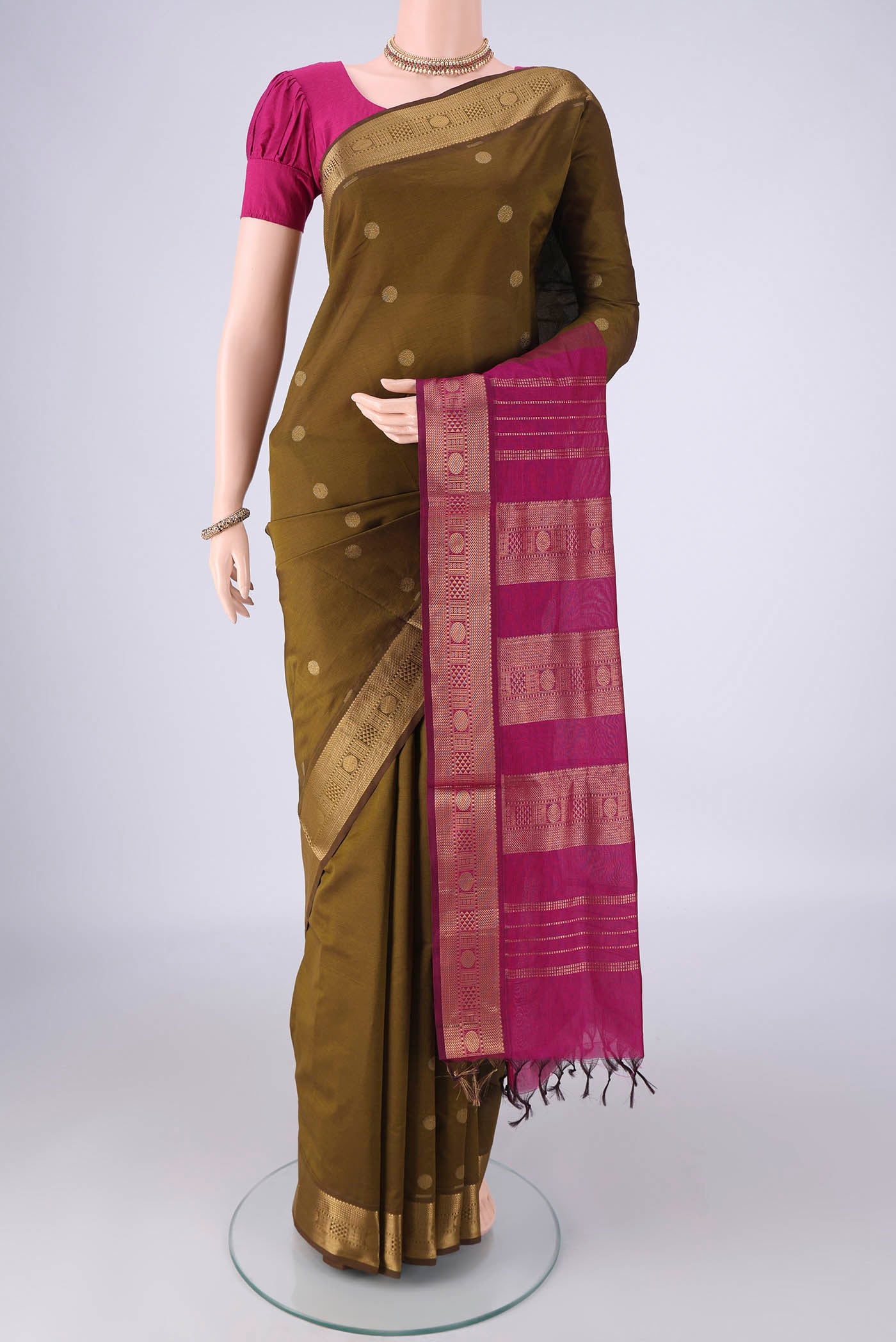 Mehandi Green Poly Cotton Saree with Zari Butta on the body and Zari Border.  displayed on a mannequin