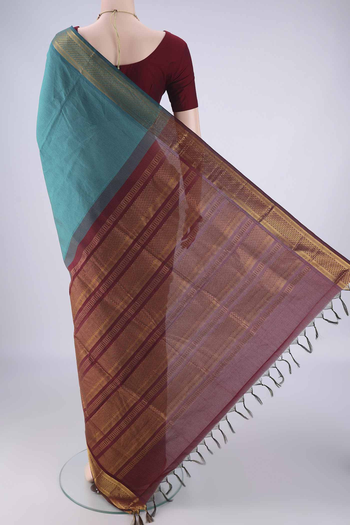 Flat view of Teal Blended Poly Cotton Saree with Stripes on the body and Zari Border. 