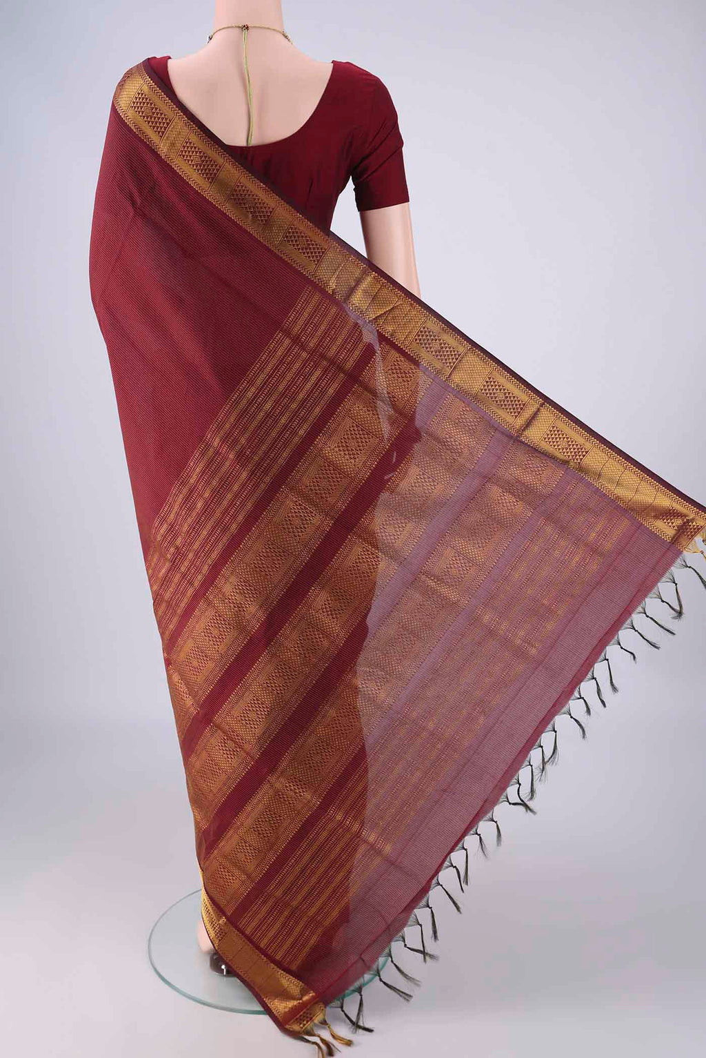 Flat view of Maroon Blended Poly Cotton Saree with Stripes on the body and Zari Border. 