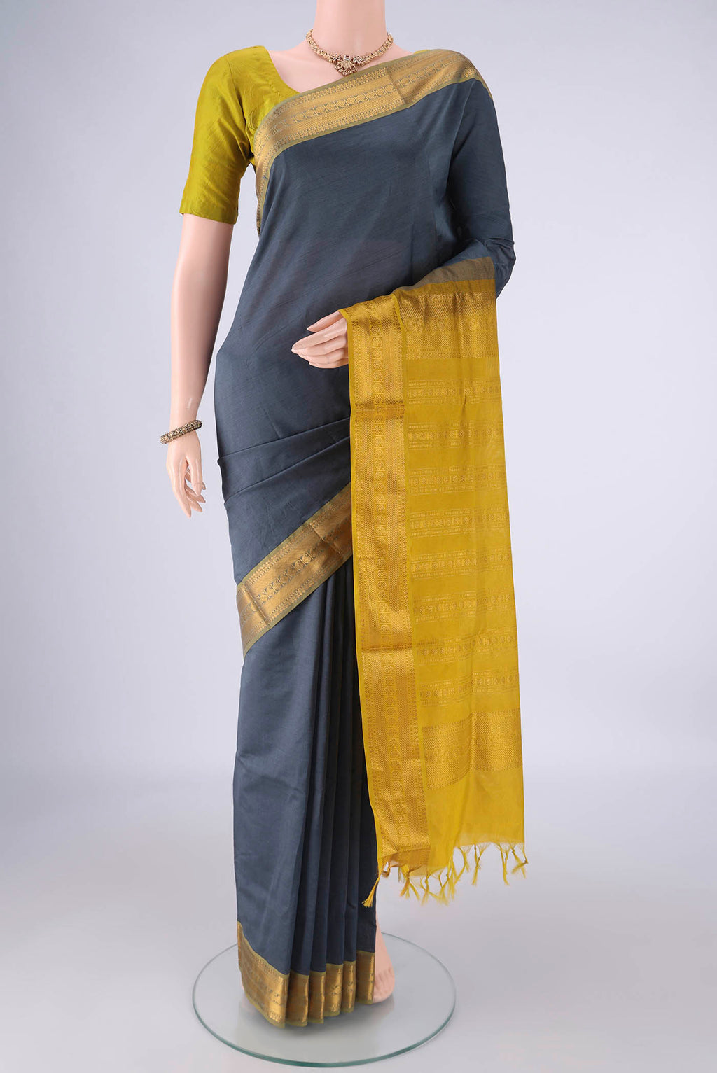 Grey Blended Poly Cotton Saree with Plain Body and Zari Border.  displayed on a mannequin