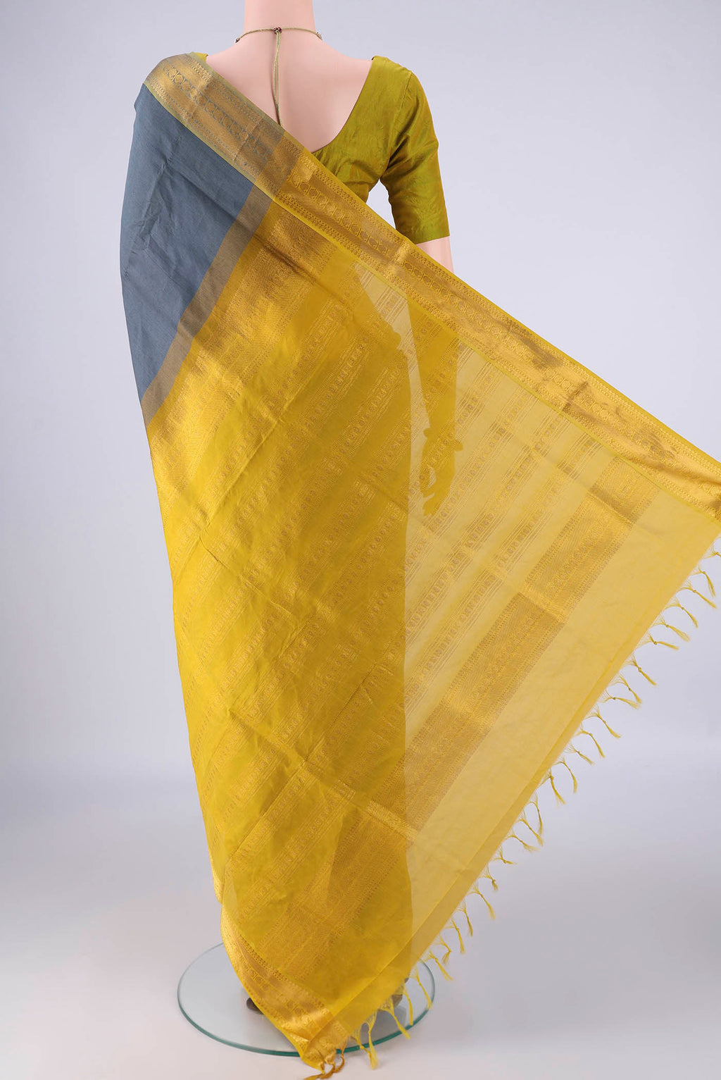 Flat view of Grey Blended Poly Cotton Saree with Plain Body and Zari Border. 