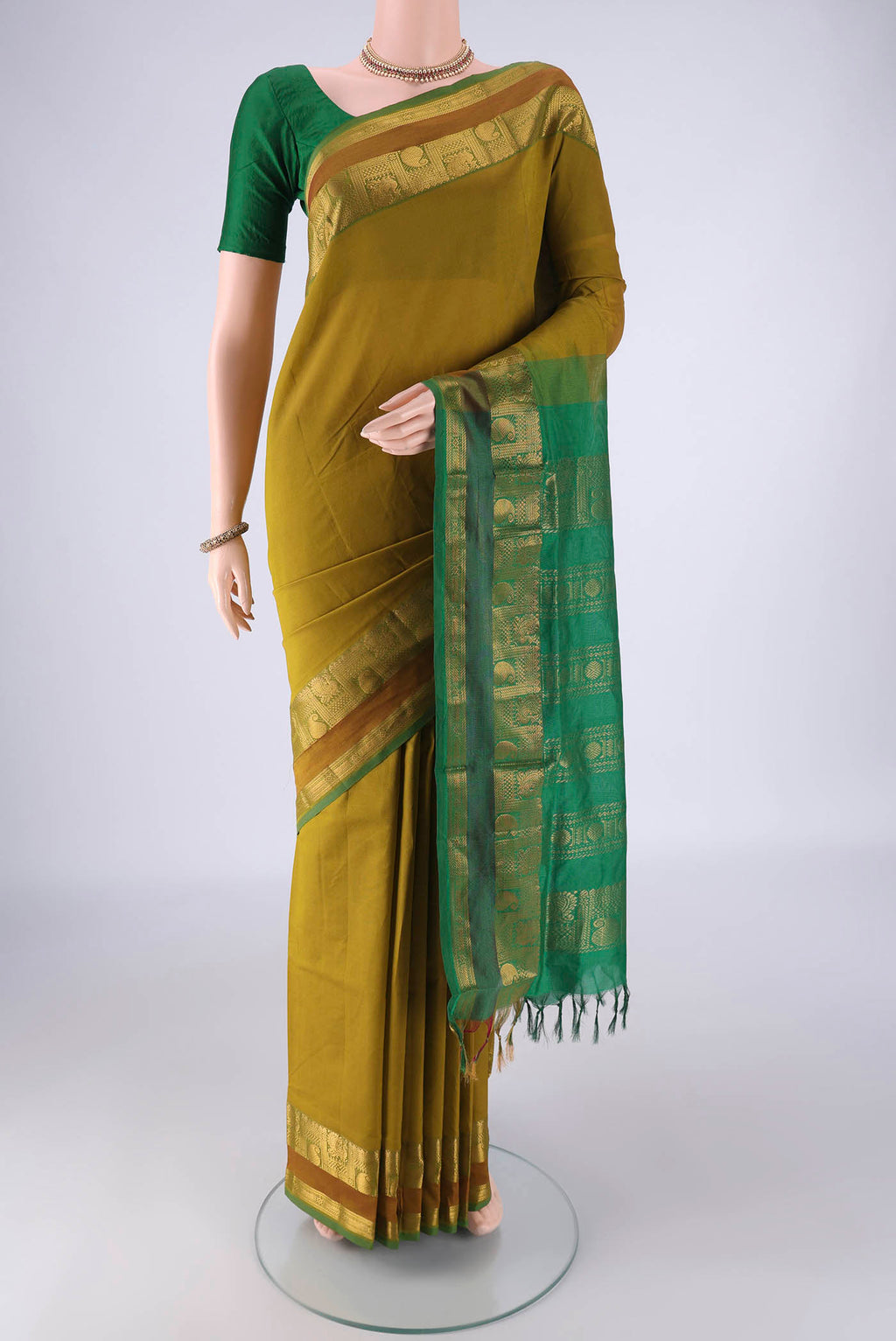 Mehandi Green Blended Poly Cotton Saree with Plain Body and Zari Border.  displayed on a mannequin