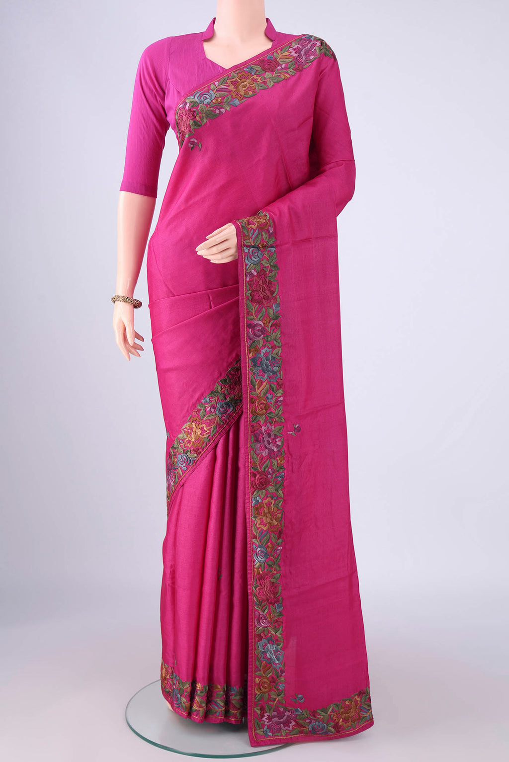 Magenta Parsi Embroidery Saree with Plain Body and Thread Border.  displayed on a mannequin