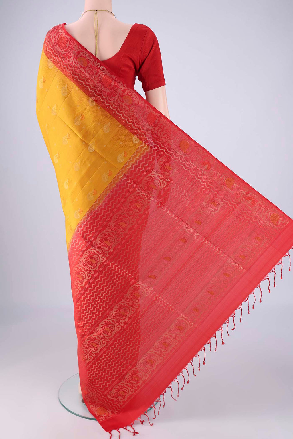 Flat view of Mustard Soft Silk Saree with Zari Butta on the body and Zari Border. 
