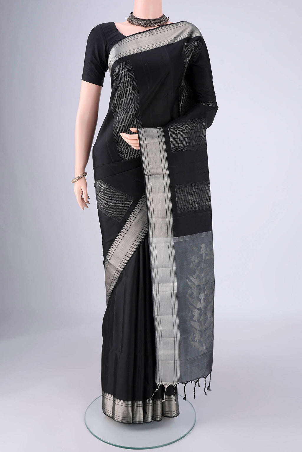 Black Soft Silk Saree with Stripes on the body and Zari Border.  displayed on a mannequin