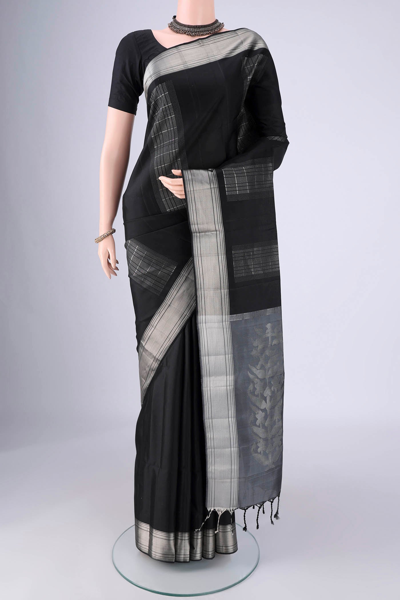 Black Soft Silk Saree with Stripes on the body and Zari Border.  displayed on a mannequin