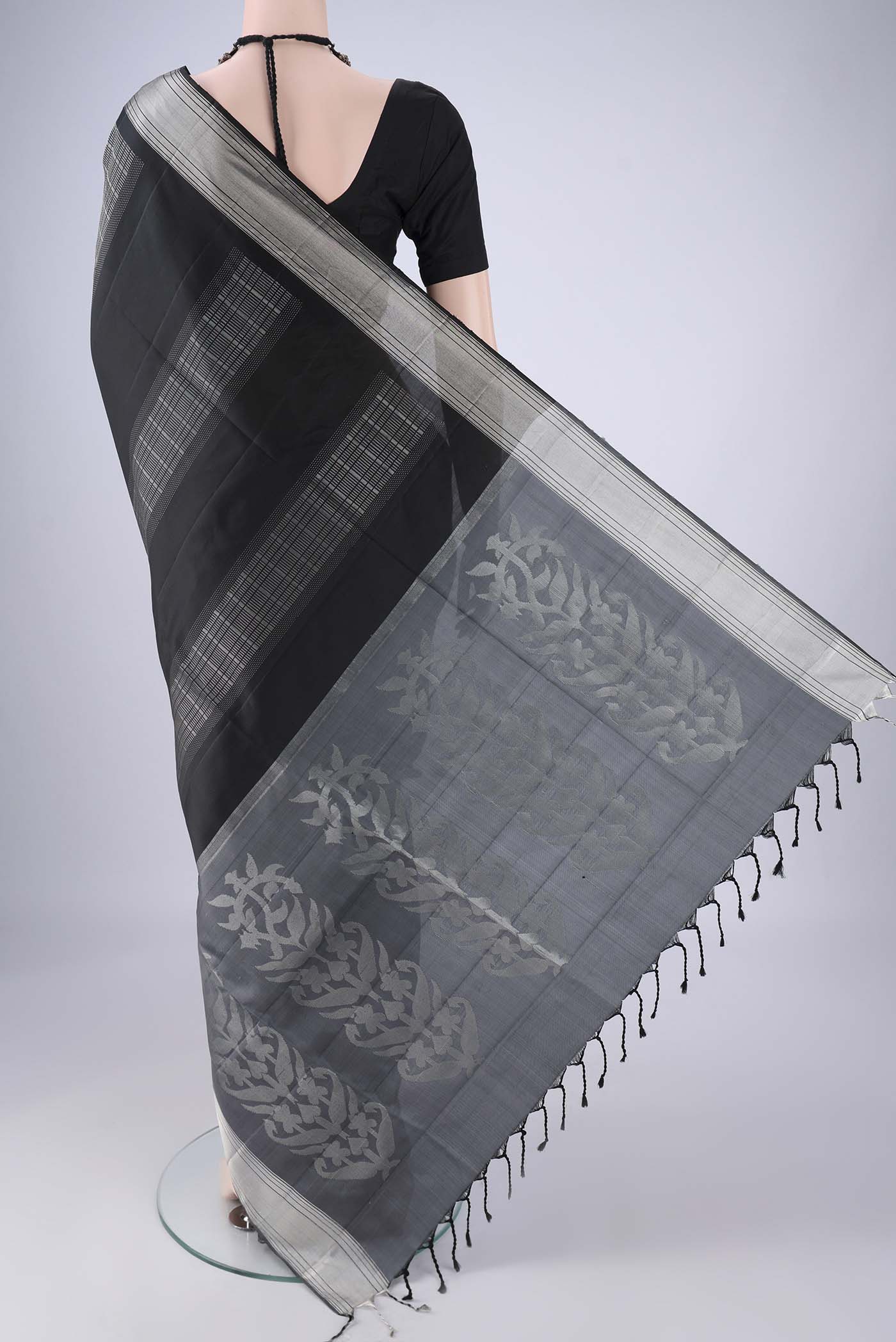 Flat view of Black Soft Silk Saree with Stripes on the body and Zari Border. 