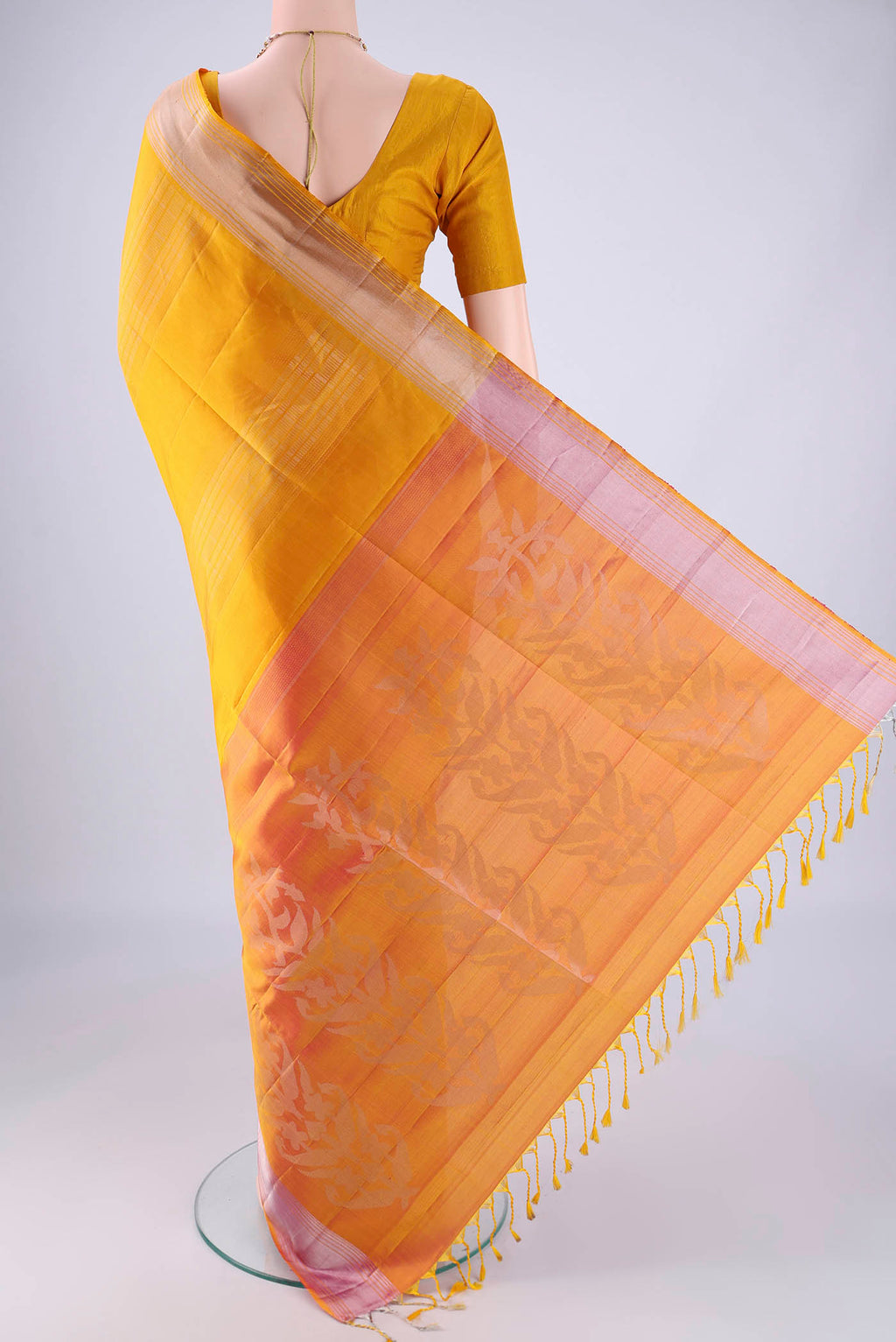 Flat view of Yellow Soft Silk Saree with Zari Butta on the body and Zari Border. 