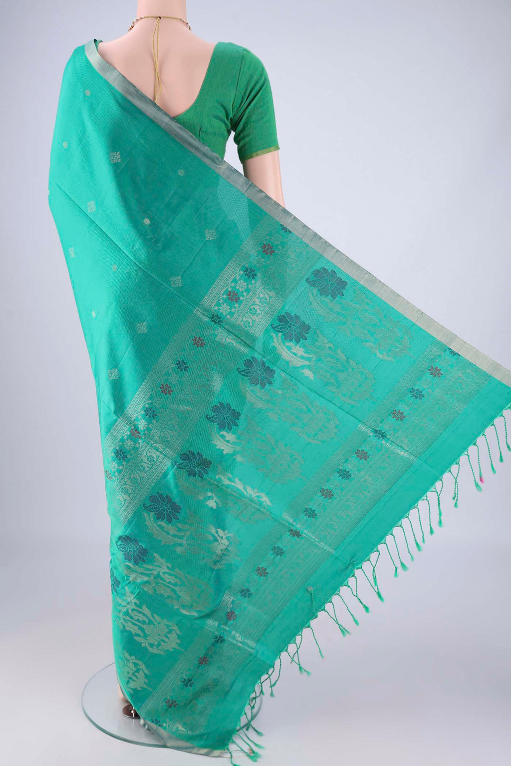 Flat view of Turquoise Soft Silk Saree with Zari Butta on the body and Zari Border. 