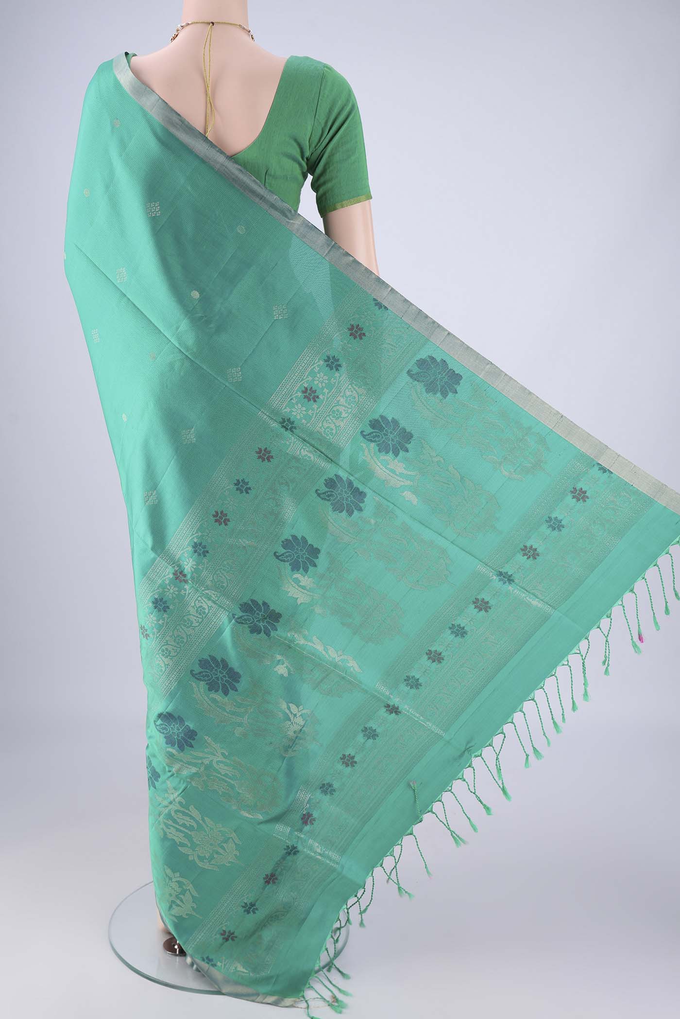 Flat view of Turquoise Soft Silk Saree with Zari Butta on the body and Zari Border. 