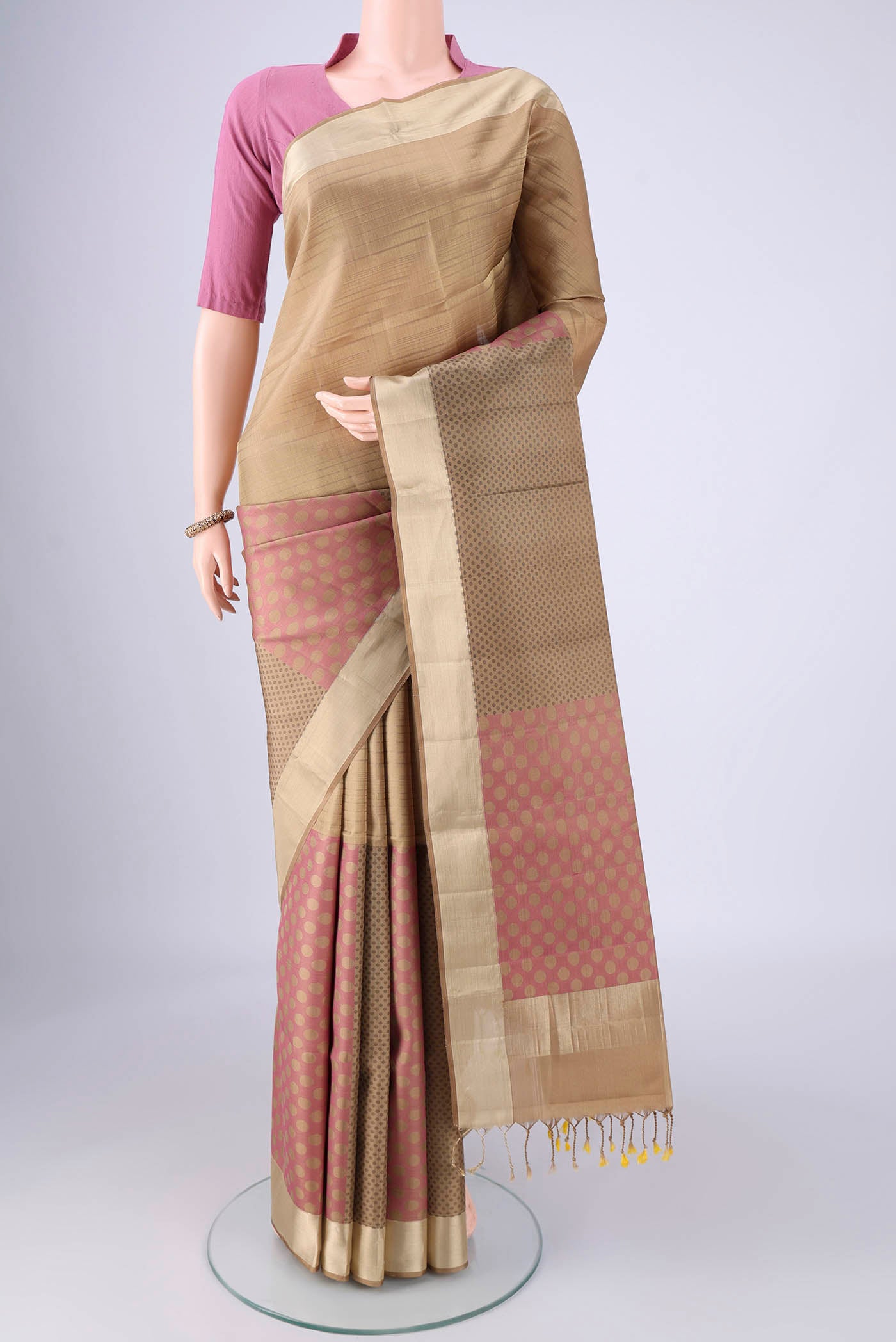 Dark Beige Soft Silk Saree with Thread Butta on the body and Zari Border.  displayed on a mannequin