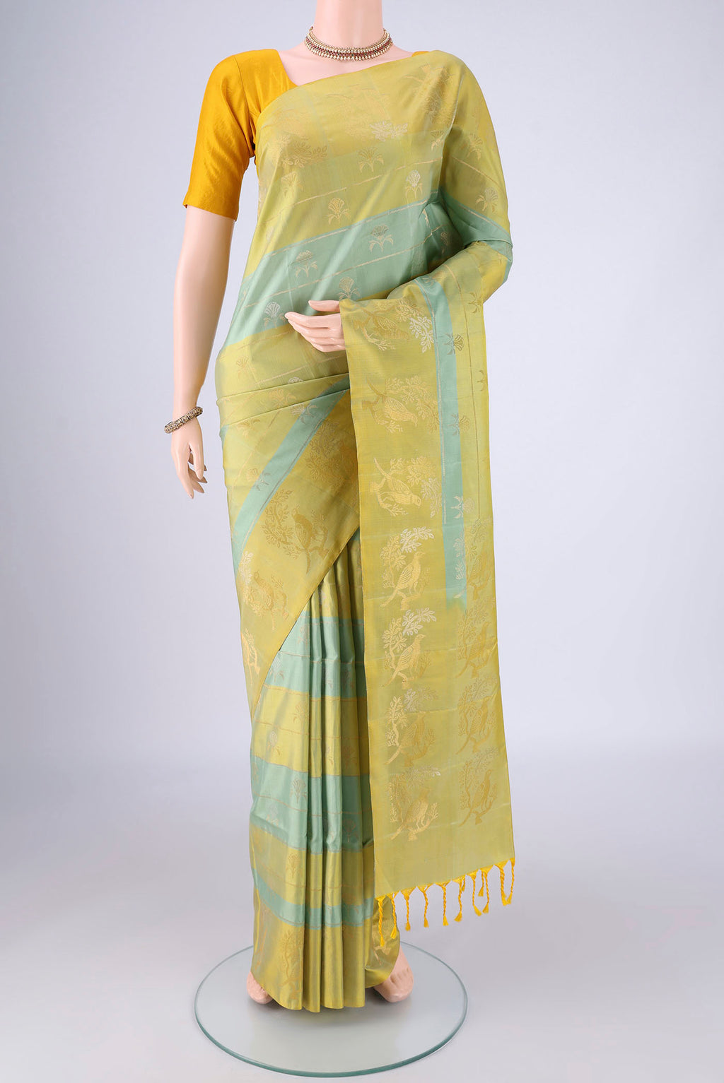 Multi Color Soft Silk Saree with Zari Butta on the body and Zari Border.  displayed on a mannequin