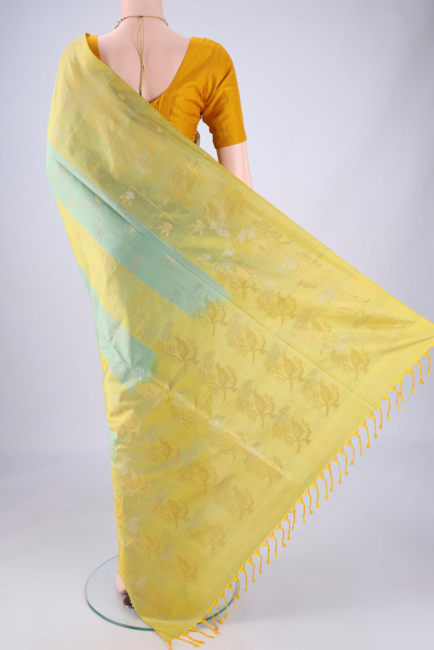 Flat view of Multi Color Soft Silk Saree with Zari Butta on the body and Zari Border. 