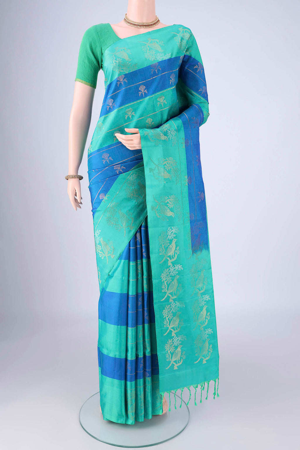 Multi Color Soft Silk Saree with Zari Butta on the body and Zari Border.  displayed on a mannequin