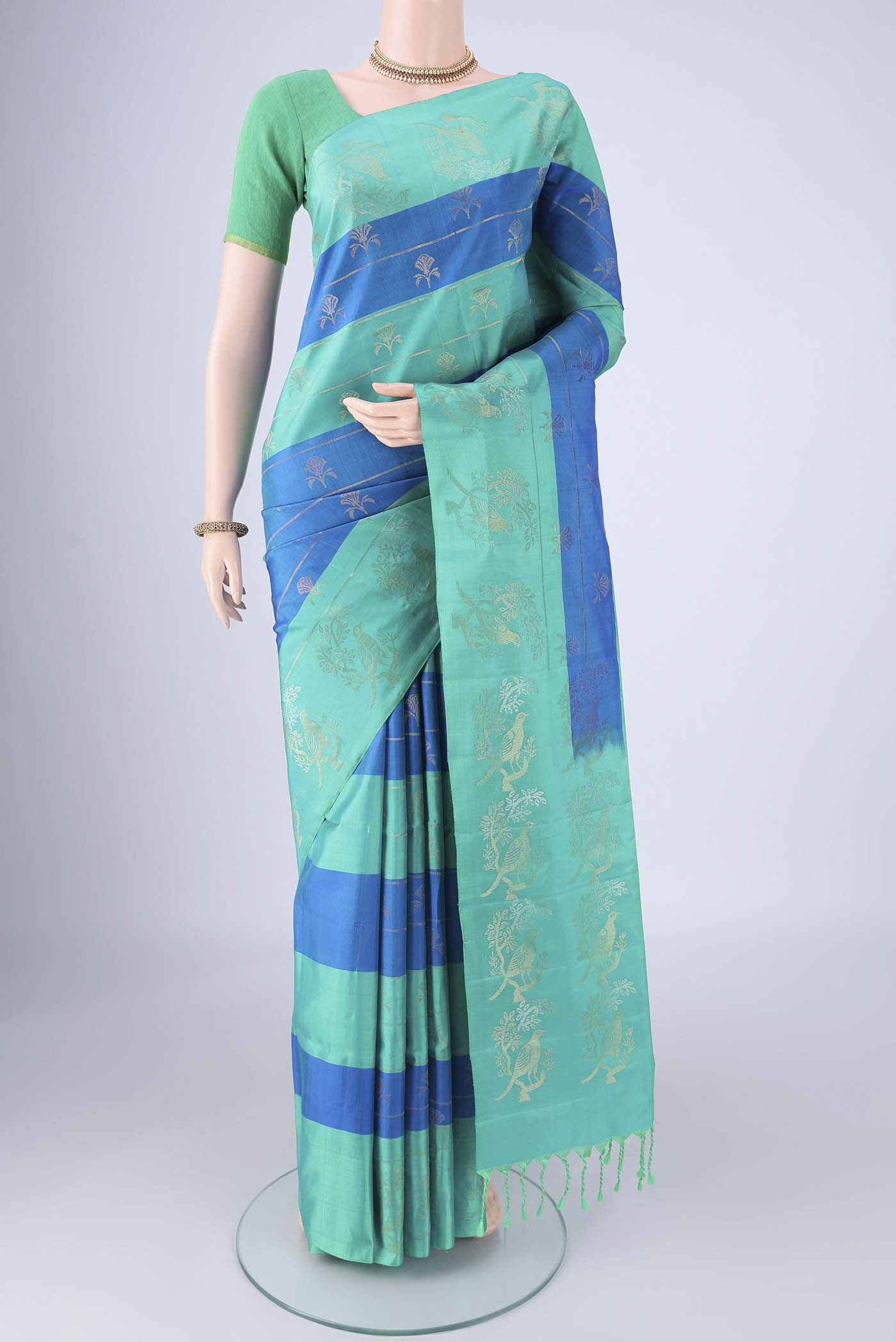 Multi Color Soft Silk Saree with Zari Butta on the body and Zari Border.  displayed on a mannequin