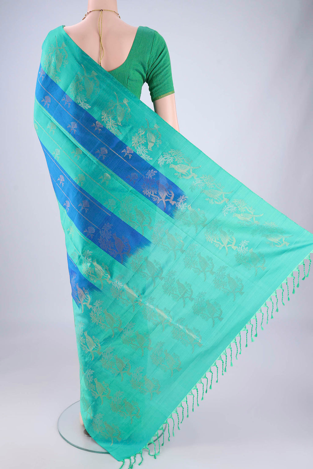 Flat view of Multi Color Soft Silk Saree with Zari Butta on the body and Zari Border. 