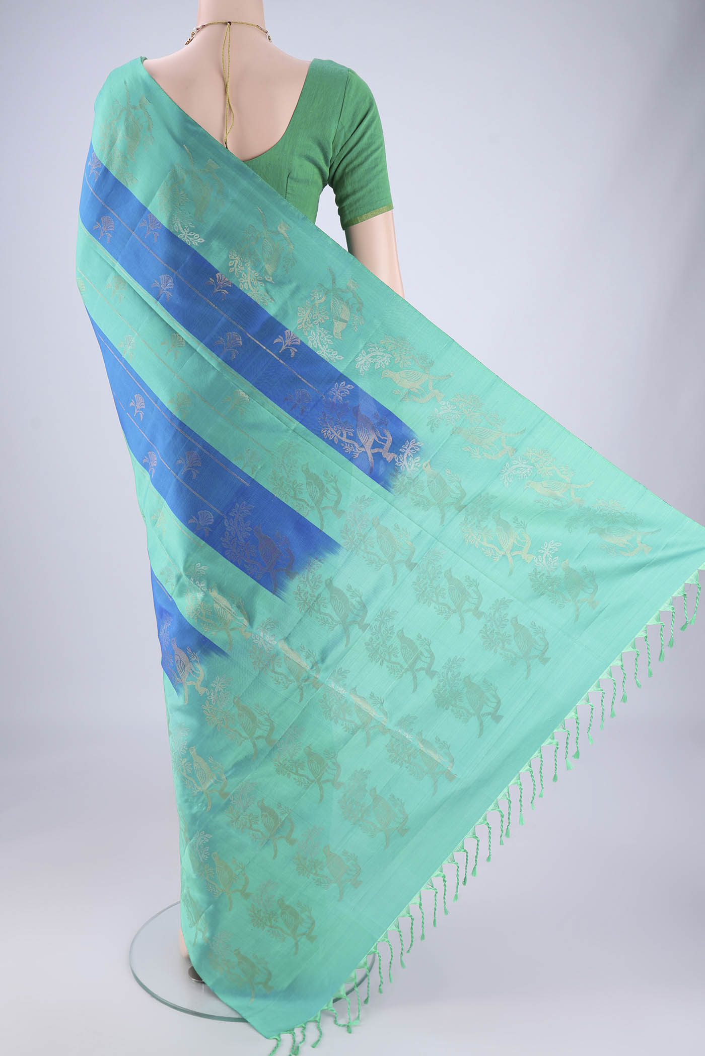 Flat view of Multi Color Soft Silk Saree with Zari Butta on the body and Zari Border. 
