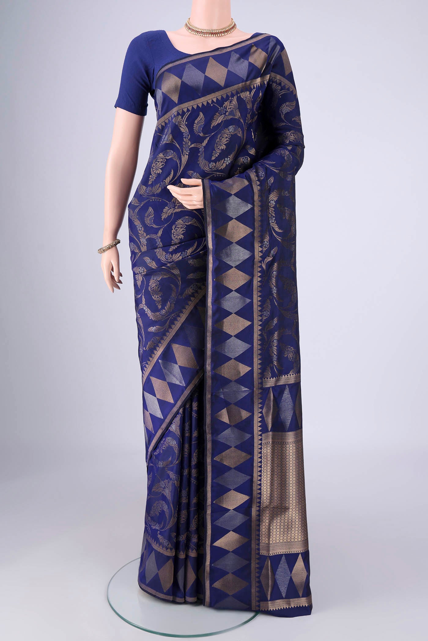 Navy Blue Soft Silk Saree with Zari Brocade on the body and Zari Border.  displayed on a mannequin