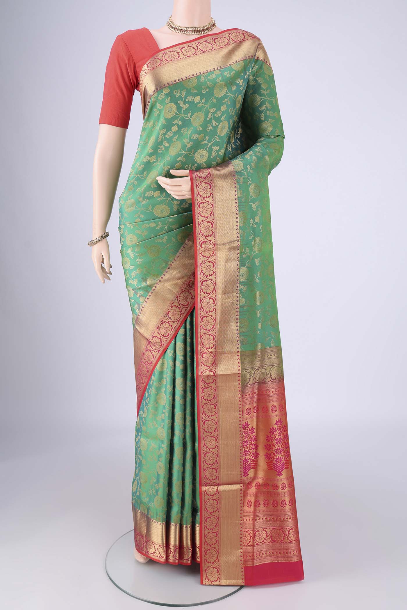 Green Soft Silk Saree with Zari Brocade on the body and Zari Border.  displayed on a mannequin