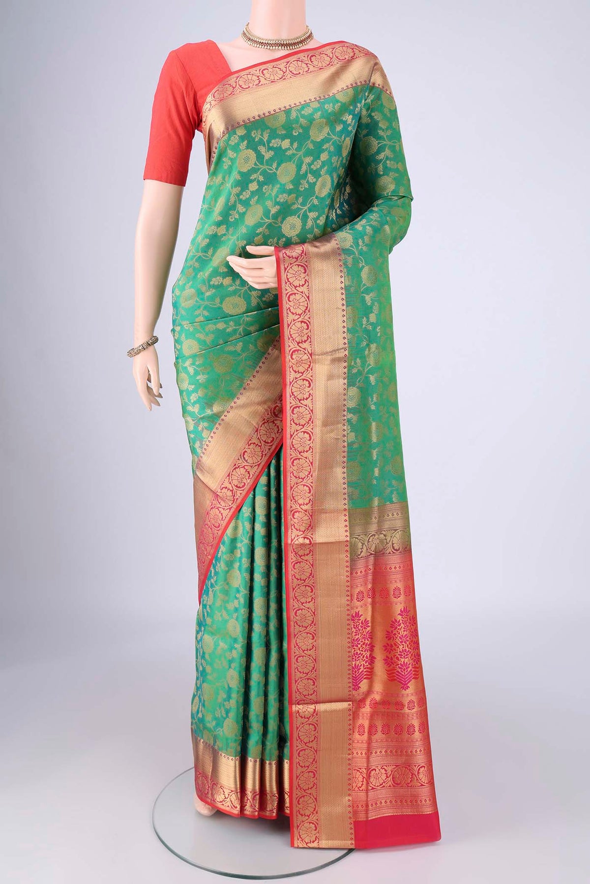 Green Soft Silk Saree with Zari Brocade on the body and Zari Border.  displayed on a mannequin