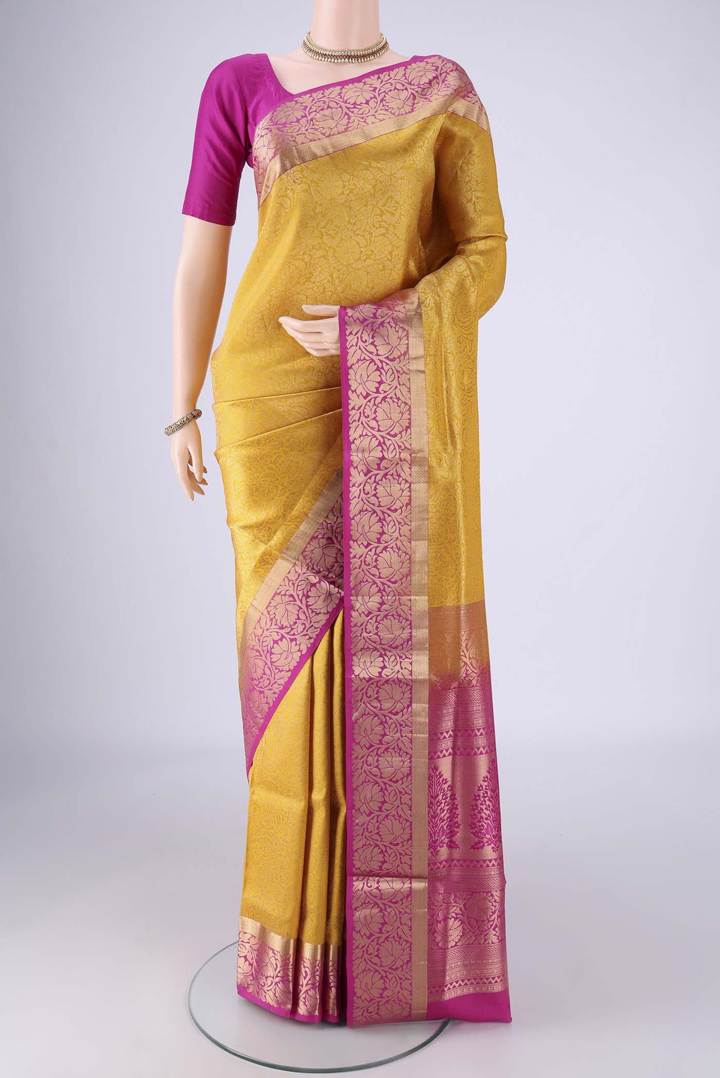 Yellow Soft Silk Saree with Zari Brocade on the body and Zari Border.  displayed on a mannequin