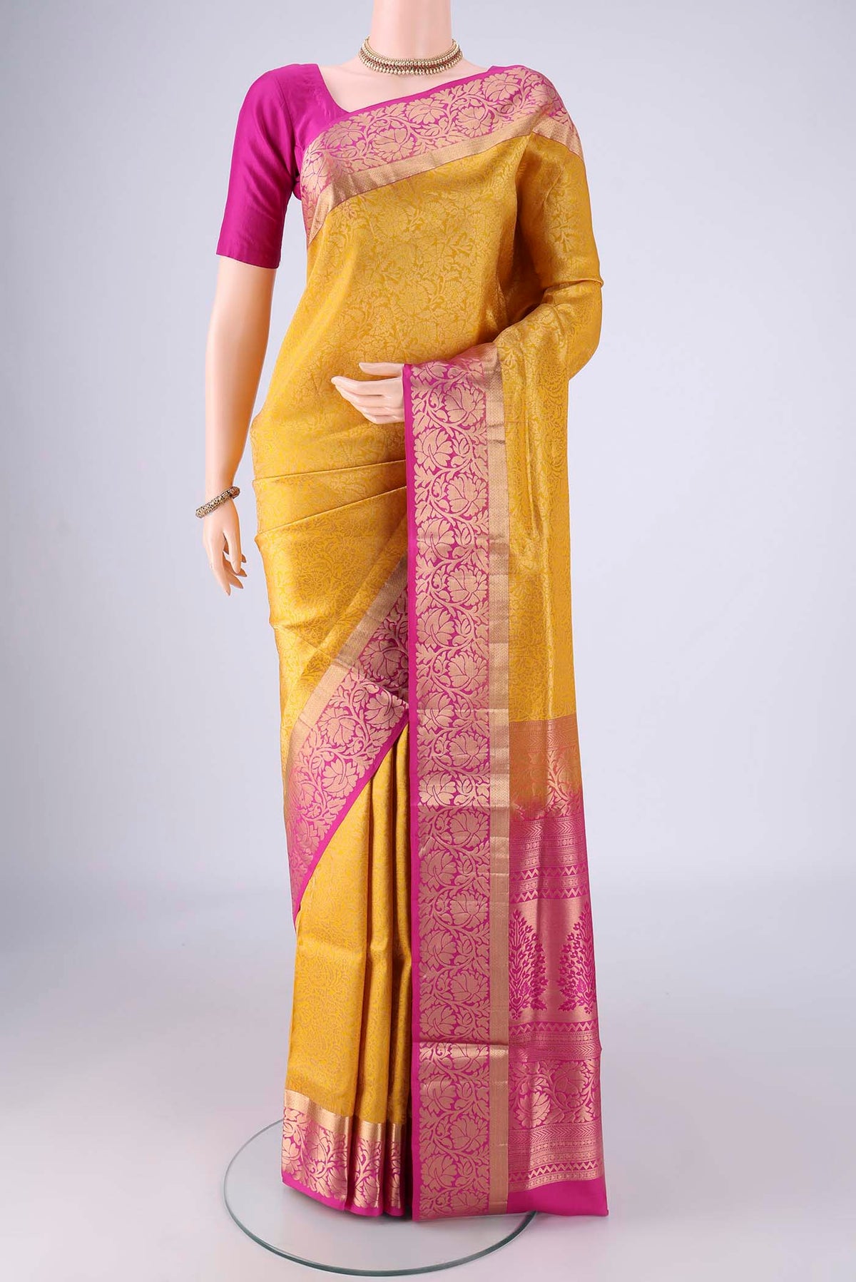 Yellow Soft Silk Saree with Zari Brocade on the body and Zari Border.  displayed on a mannequin