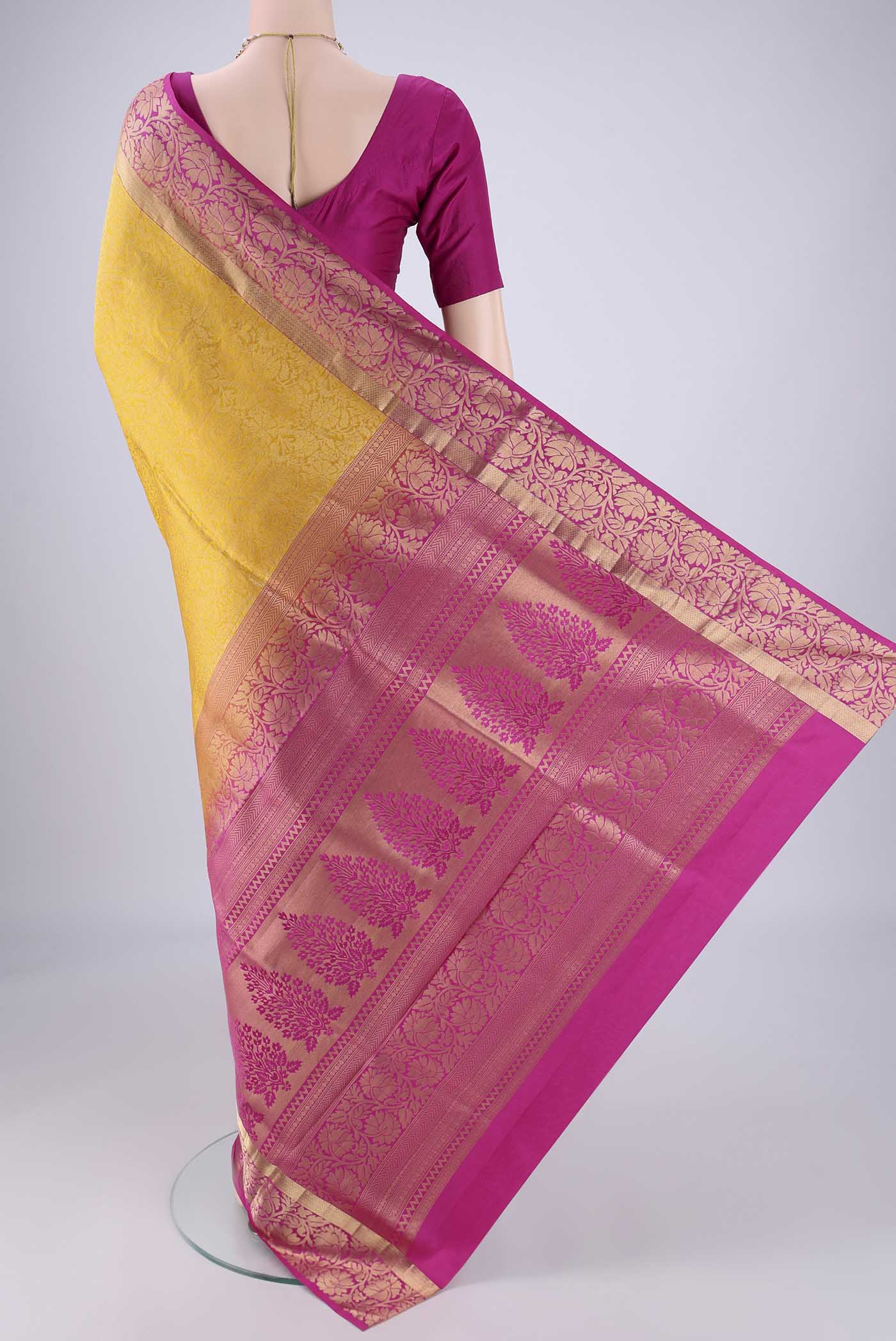Flat view of Yellow Soft Silk Saree with Zari Brocade on the body and Zari Border. 