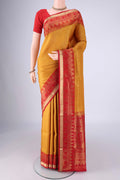 Mustard Soft Silk Saree with Zari Brocade on the body and Zari Border.  displayed on a mannequin