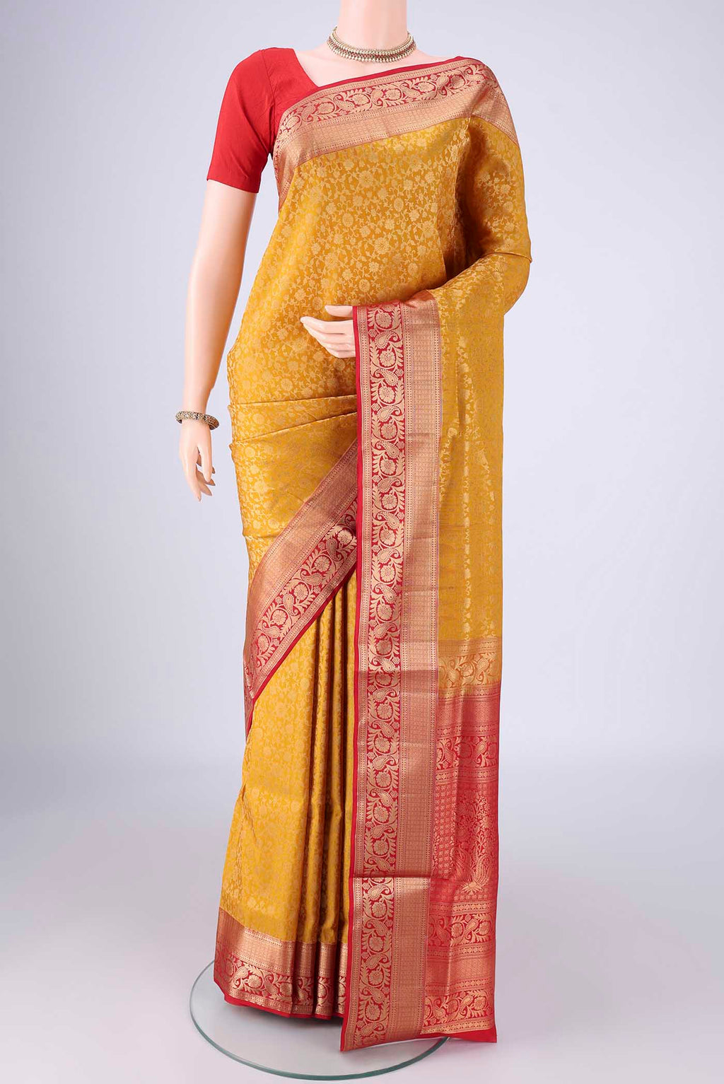 Yellow Soft Silk Saree with Zari Brocade on the body and Zari Border.  displayed on a mannequin