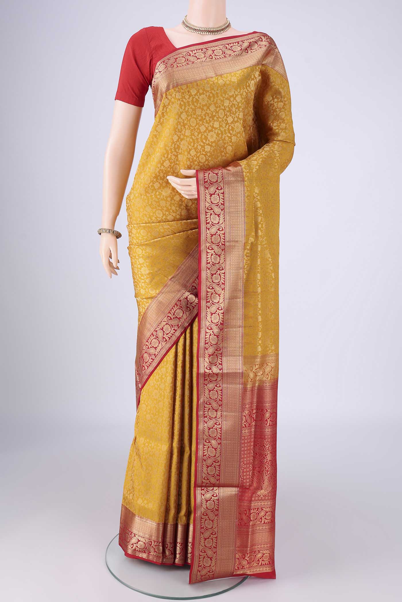 Yellow Soft Silk Saree with Zari Brocade on the body and Zari Border.  displayed on a mannequin