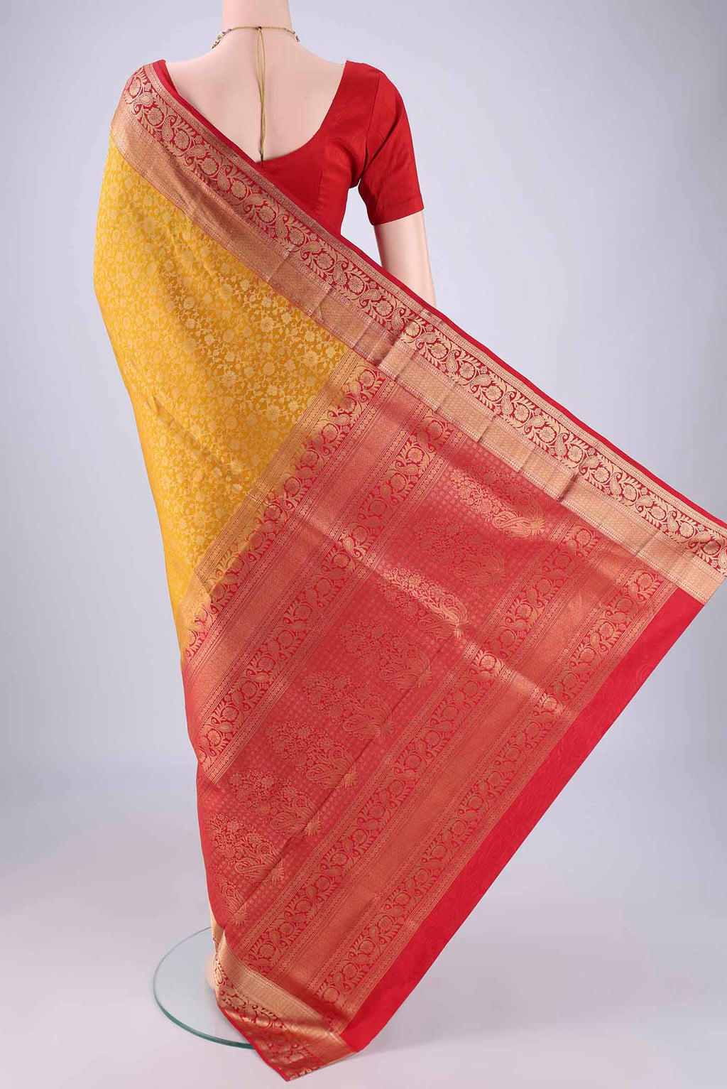 Flat view of Yellow Soft Silk Saree with Zari Brocade on the body and Zari Border. 