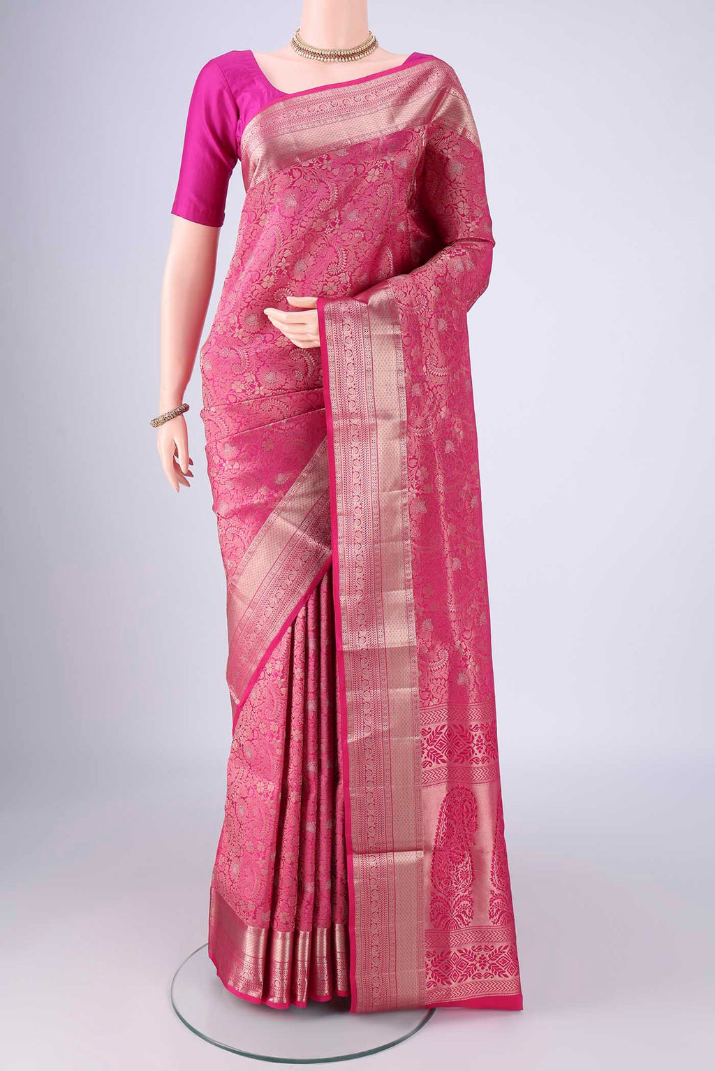 Rani Pink Soft Silk Saree with Zari Brocade on the body and Zari Border.  displayed on a mannequin