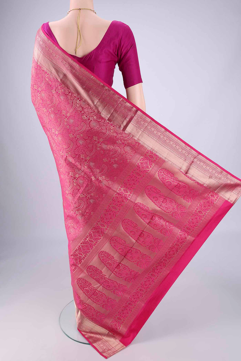 Flat view of Rani Pink Soft Silk Saree with Zari Brocade on the body and Zari Border. 