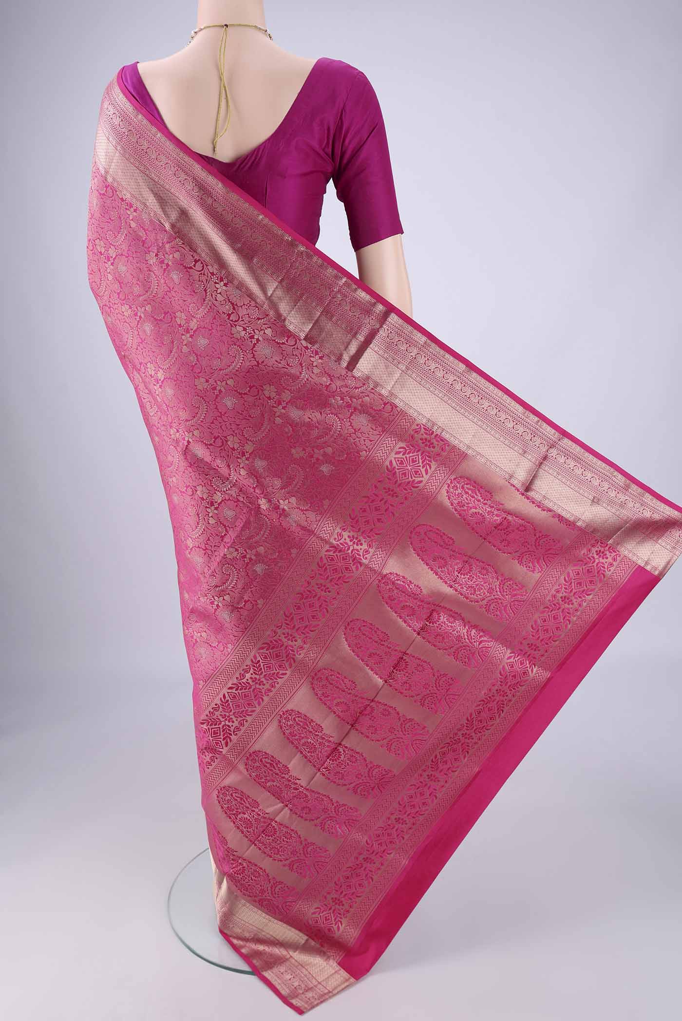 Flat view of Rani Pink Soft Silk Saree with Zari Brocade on the body and Zari Border. 