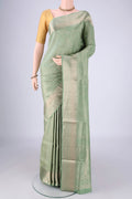 Light Green Soft Silk Saree with Zari Brocade on the body and Zari Border.  displayed on a mannequin