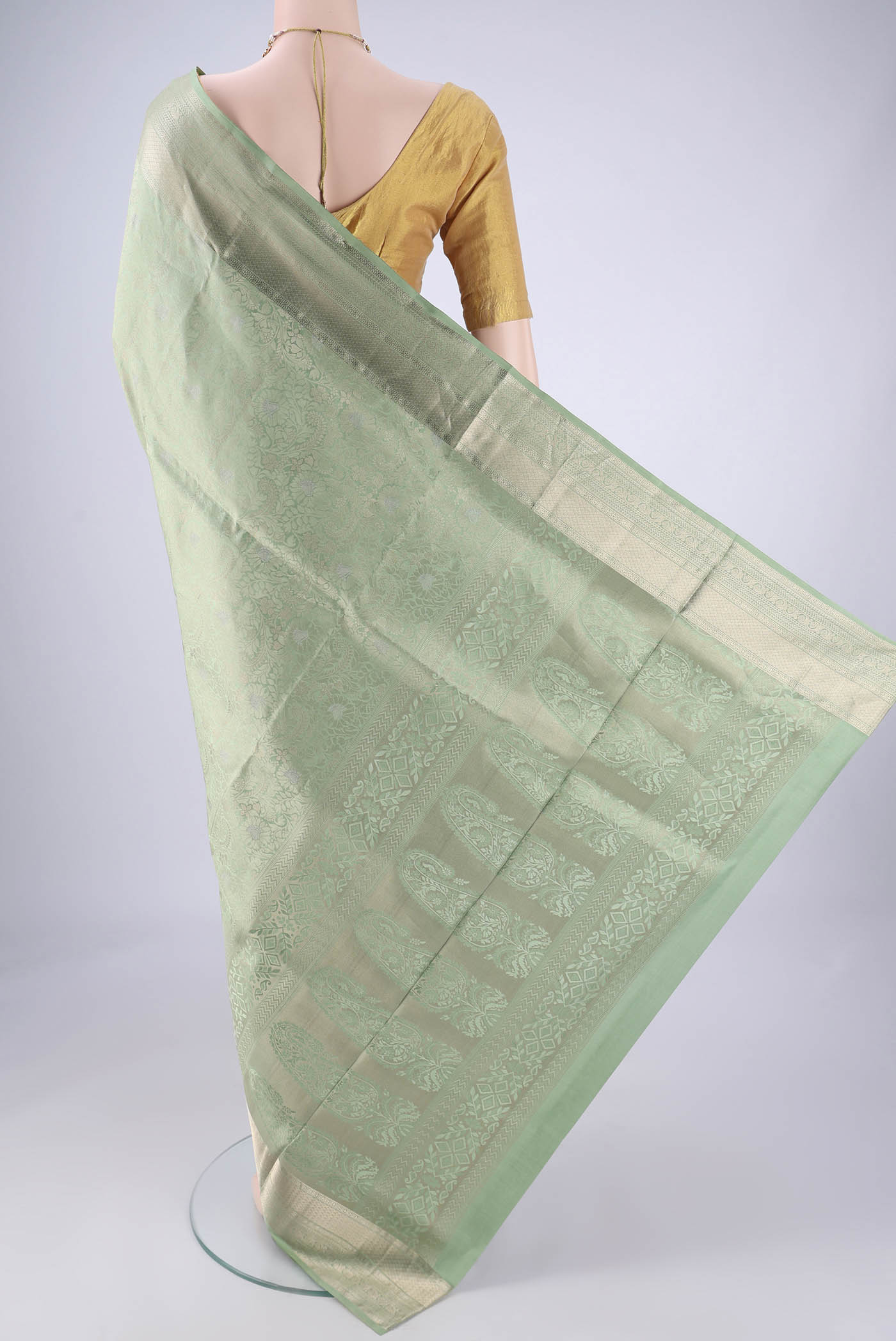 Flat view of Light Green Soft Silk Saree with Zari Brocade on the body and Zari Border. 