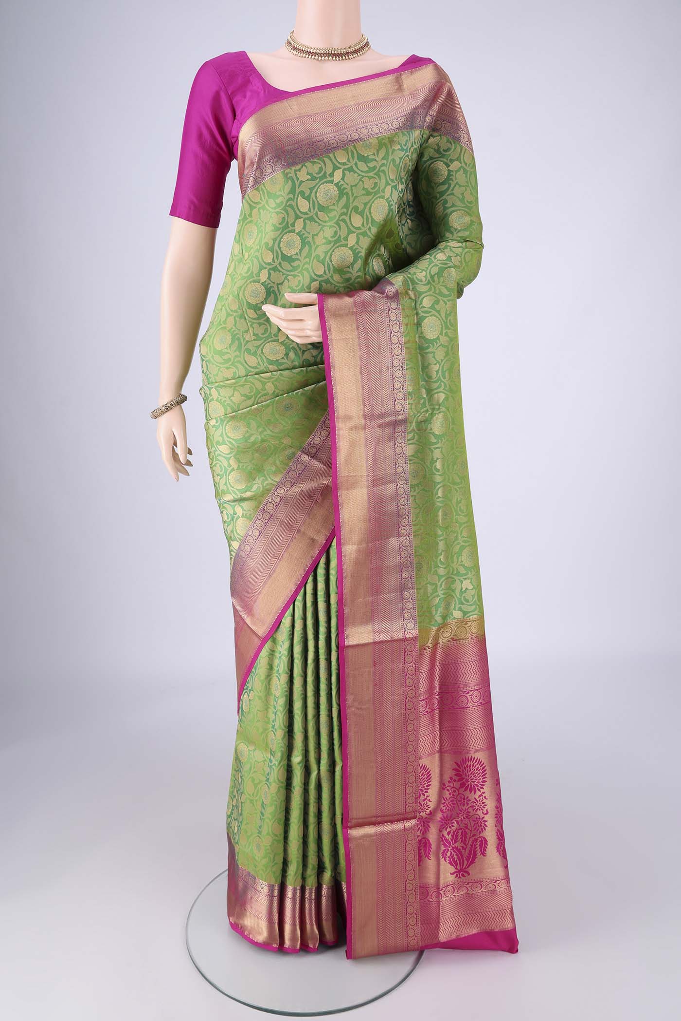 Green Soft Silk Saree with Zari Brocade on the body and Zari Border.  displayed on a mannequin