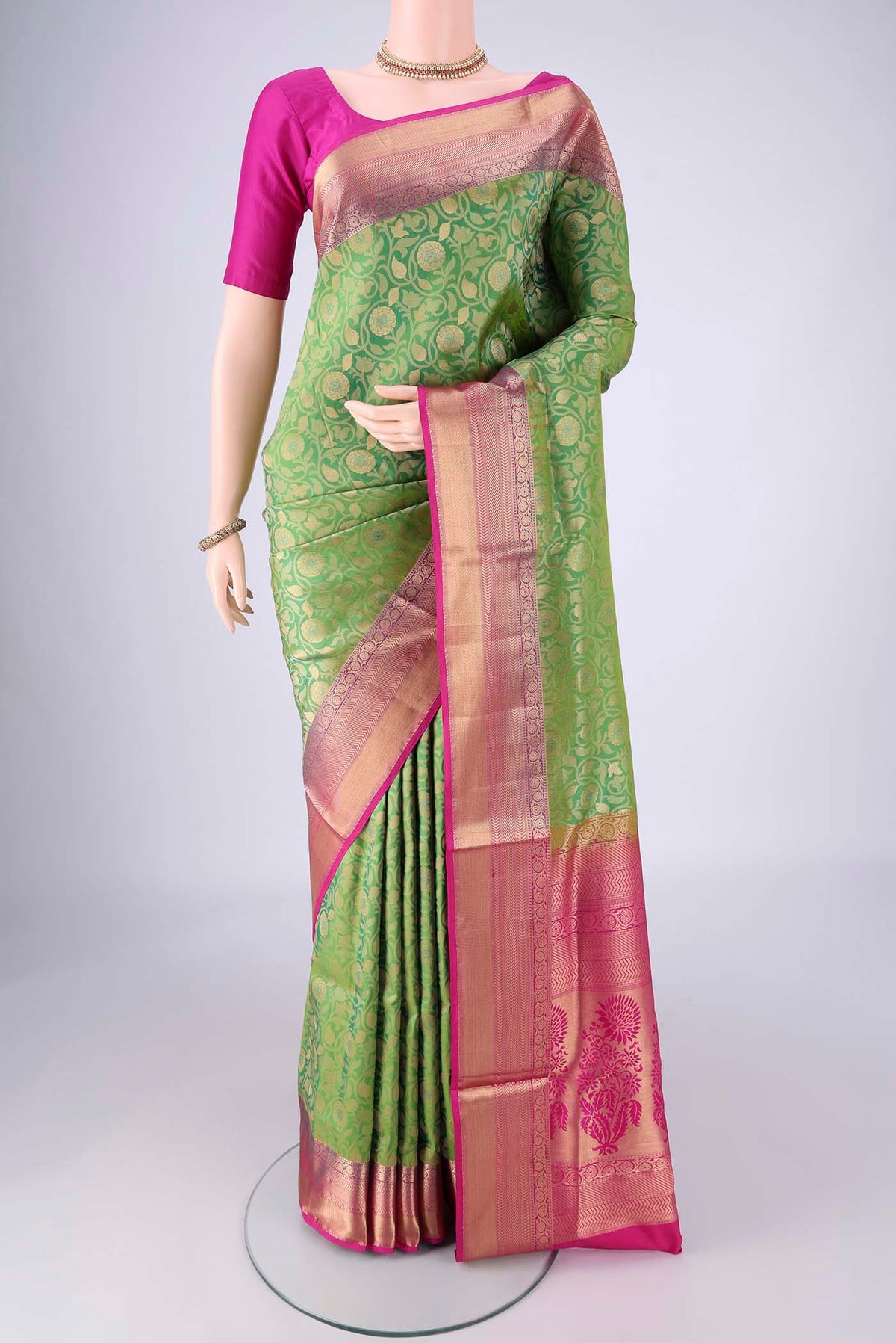 Green Soft Silk Saree with Zari Brocade on the body and Zari Border.  displayed on a mannequin