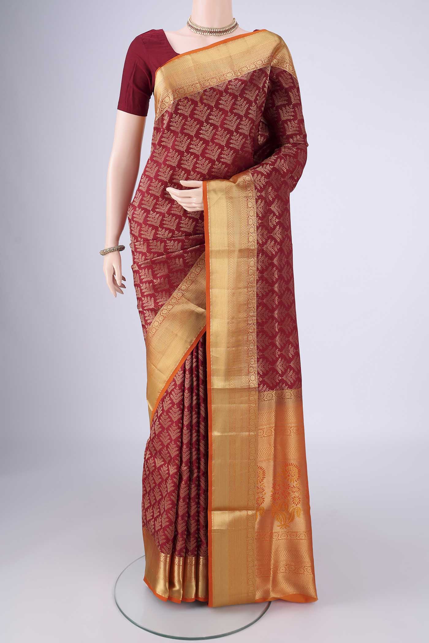Maroon Soft Silk Saree with Zari Brocade on the body and Zari Border.  displayed on a mannequin