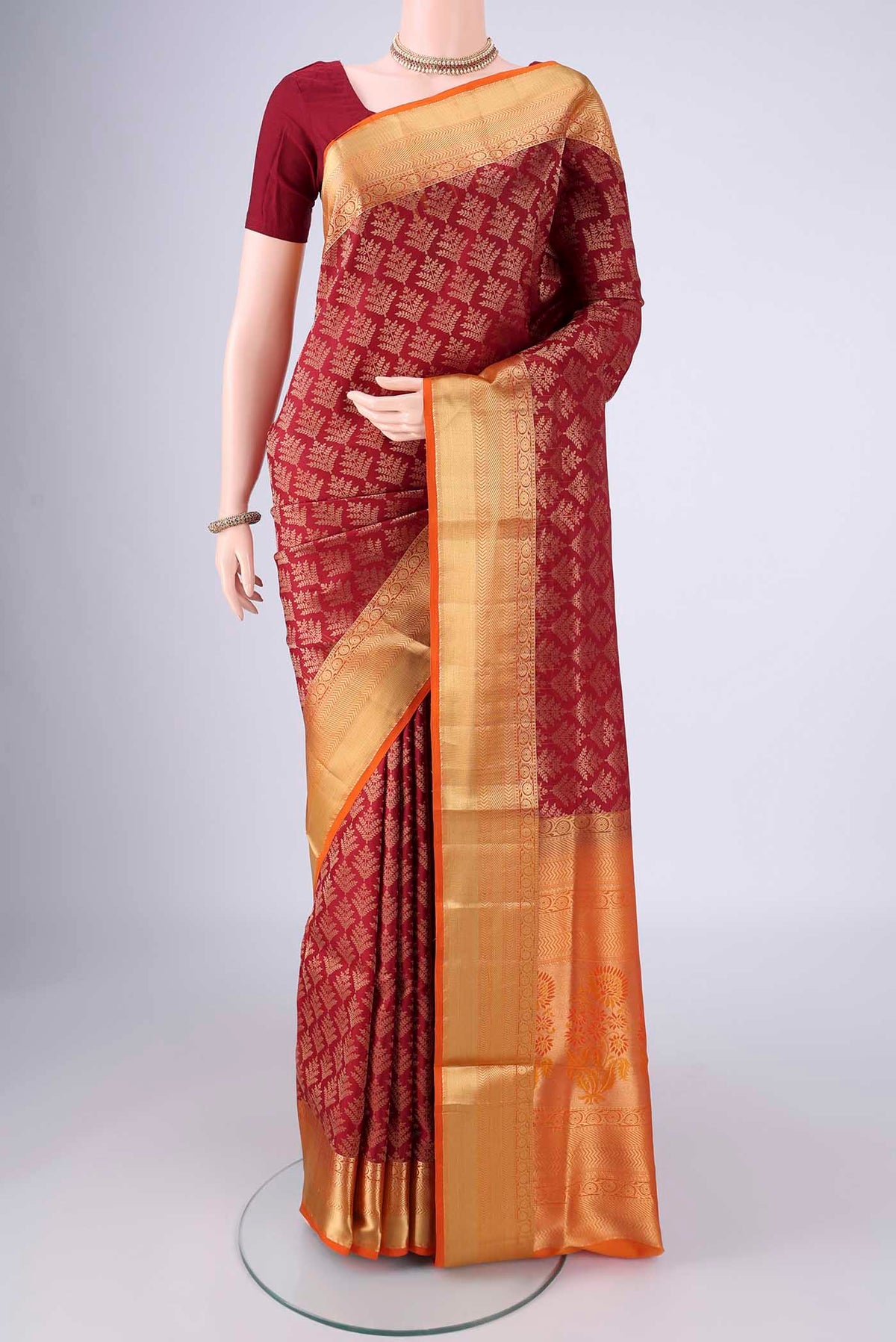 Maroon Soft Silk Saree with Zari Brocade on the body and Zari Border.  displayed on a mannequin