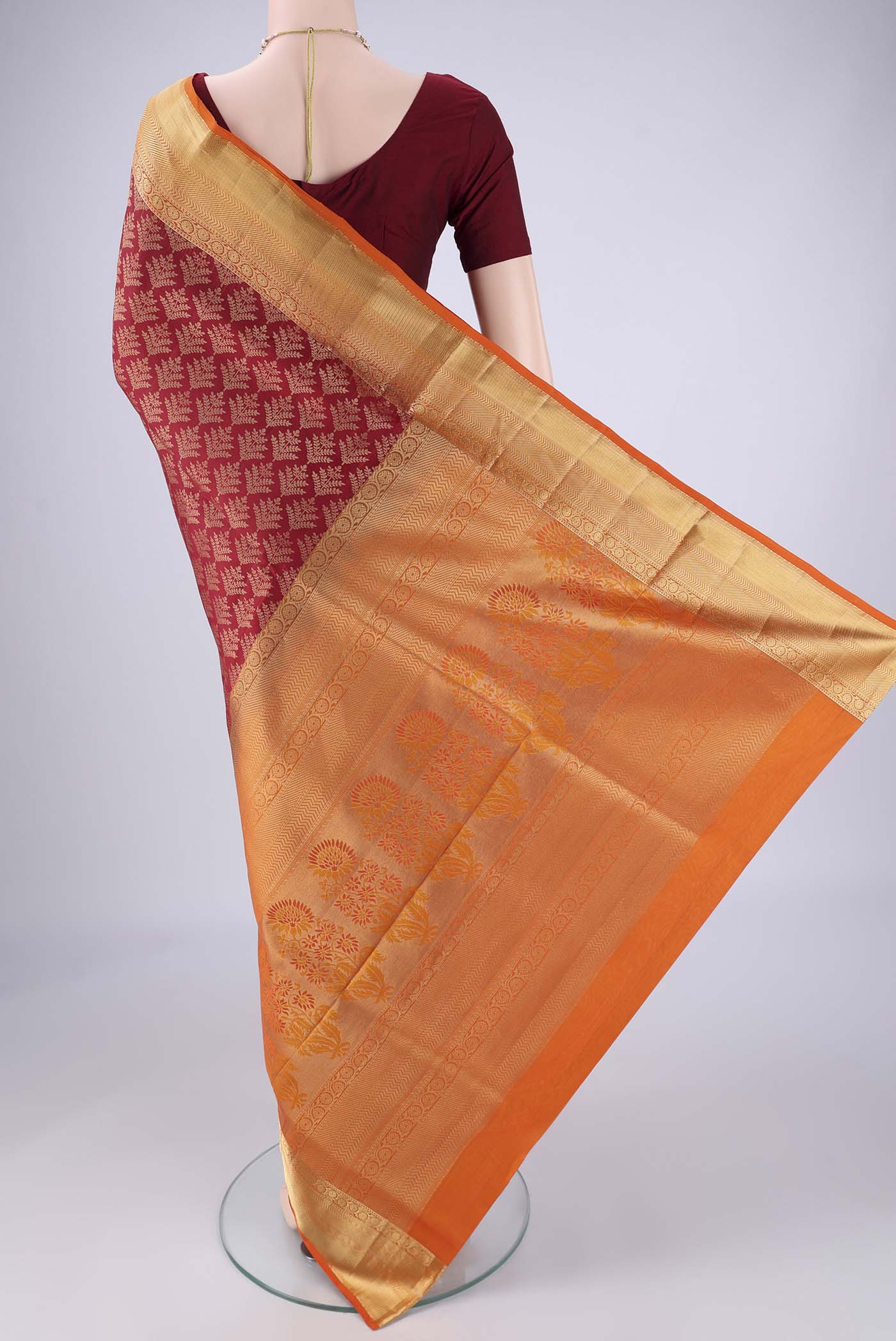 Flat view of Maroon Soft Silk Saree with Zari Brocade on the body and Zari Border. 
