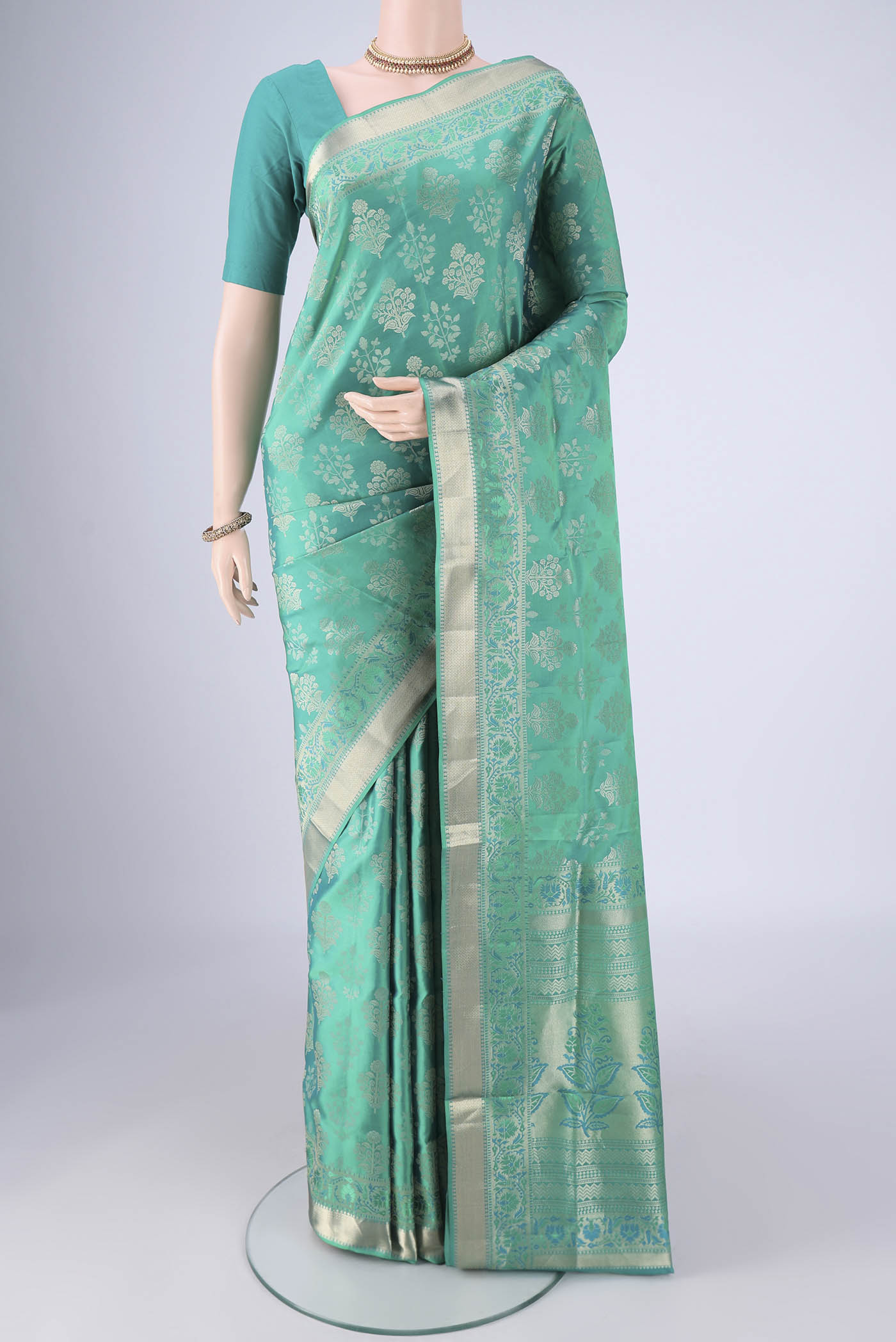 Turquoise Dual Tone Soft Silk Saree with Zari Butta on the body and Zari Border.  displayed on a mannequin