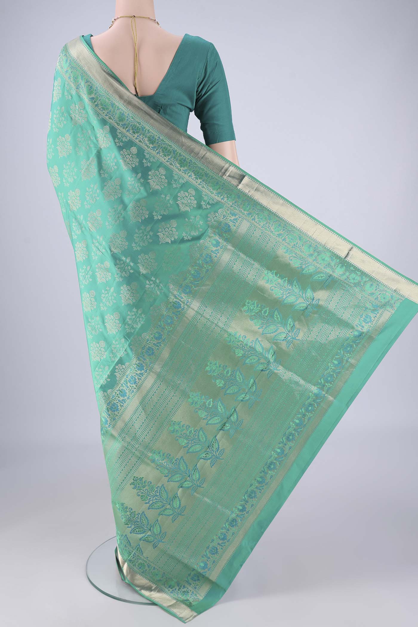 Flat view of Turquoise Dual Tone Soft Silk Saree with Zari Butta on the body and Zari Border. 