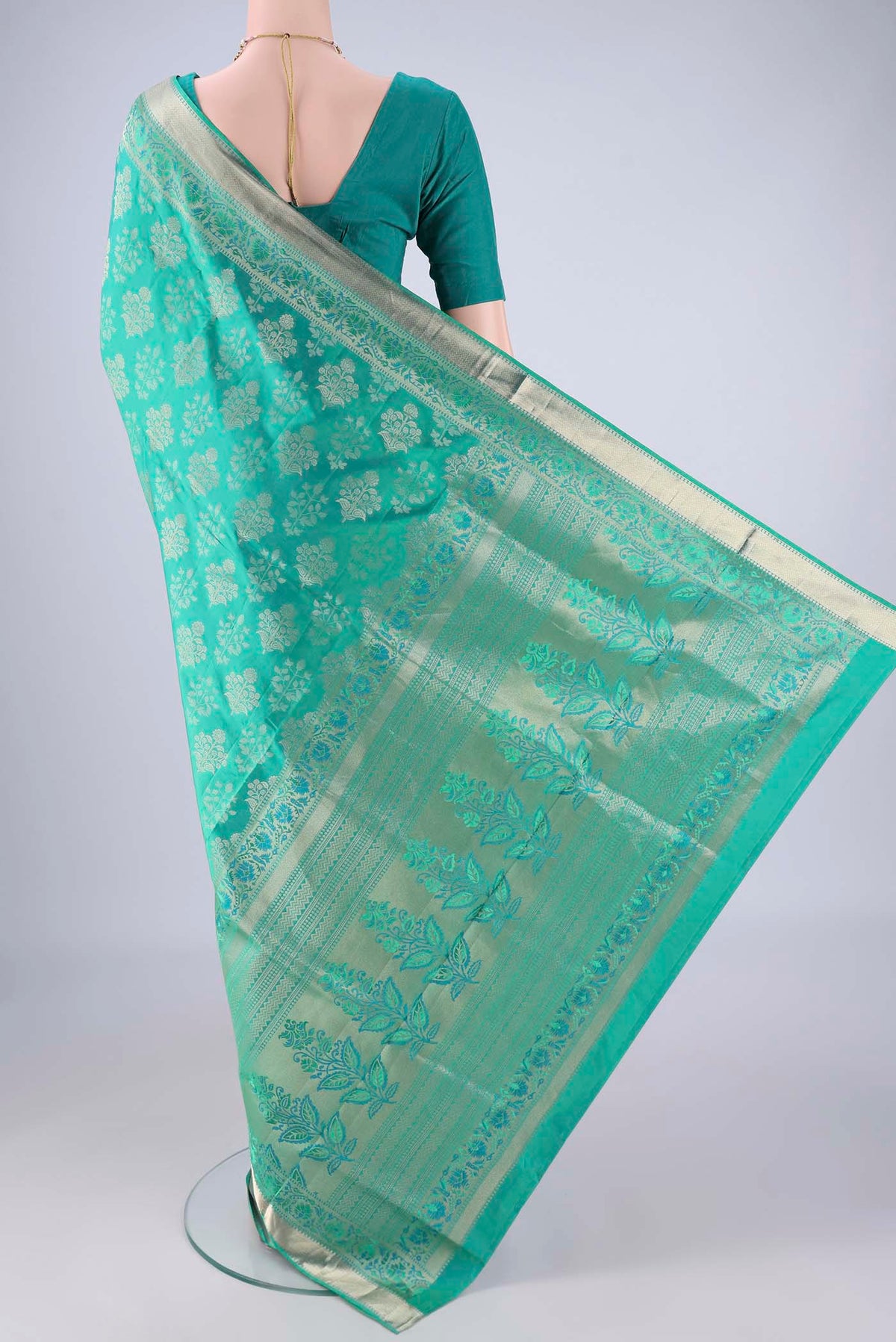Flat view of Turquoise Dual Tone Soft Silk Saree with Zari Butta on the body and Zari Border. 