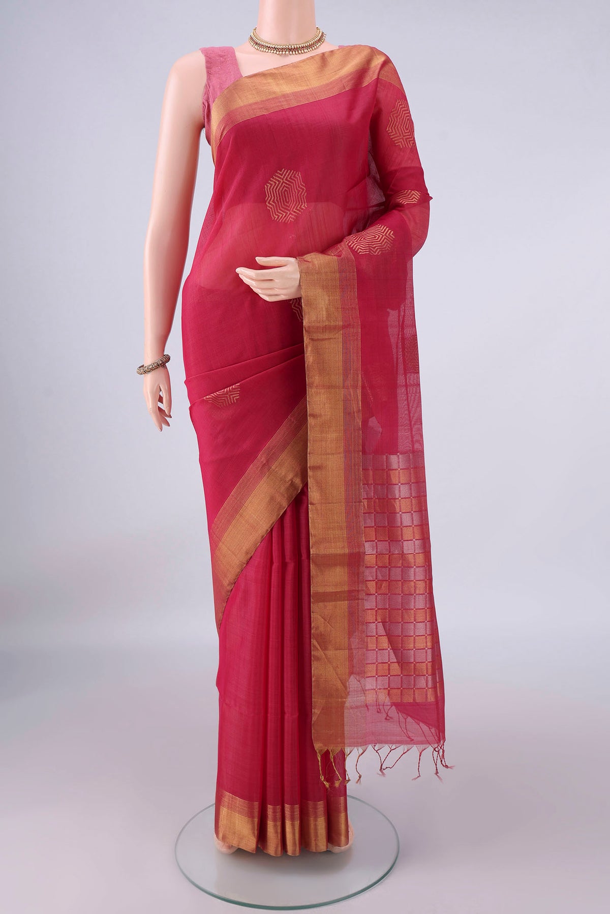 Coral Silk Cotton Saree with Zari Butta on the body and Zari Border.  displayed on a mannequin